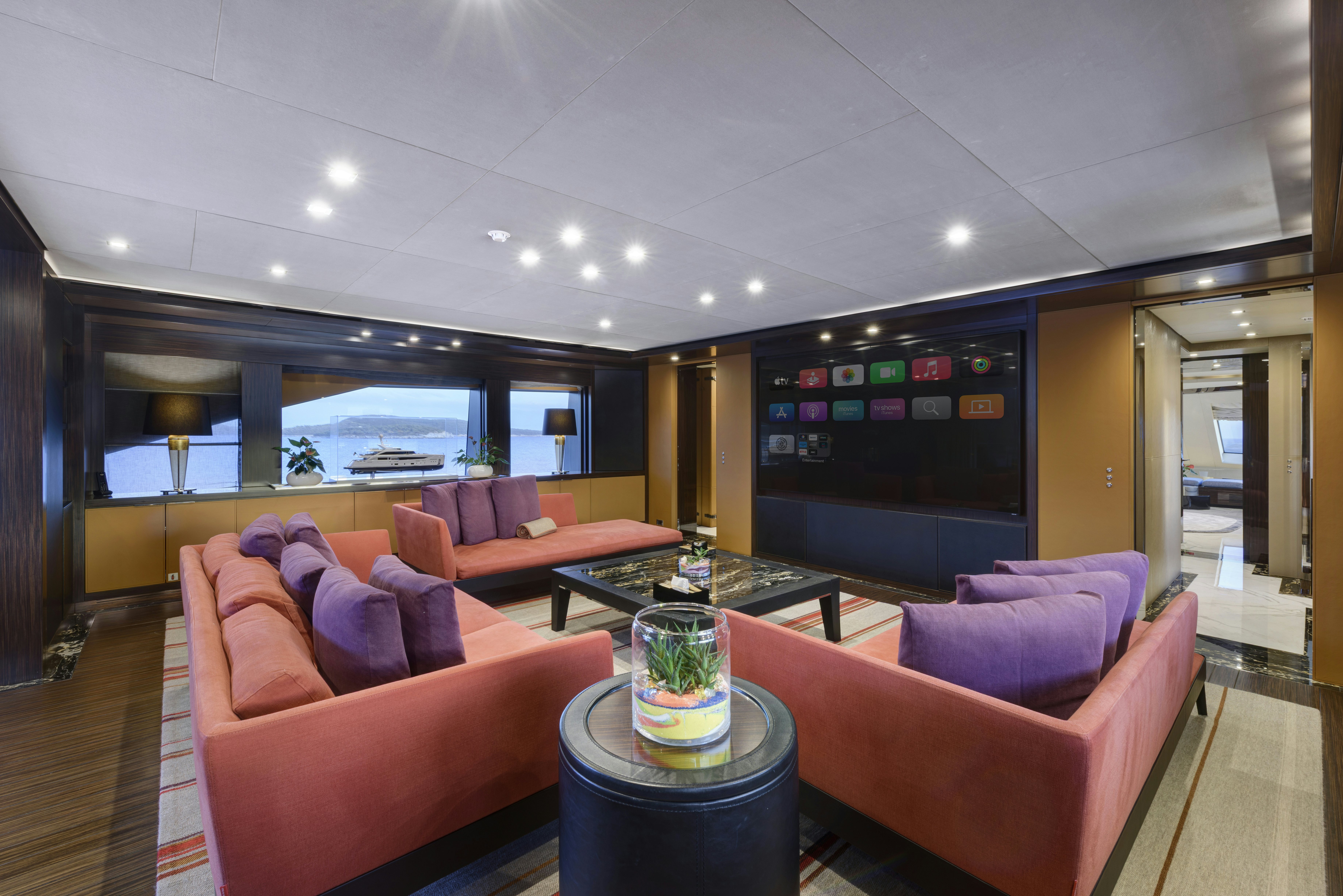 a living room with a large screen aboard SERENITY Yacht for Sale