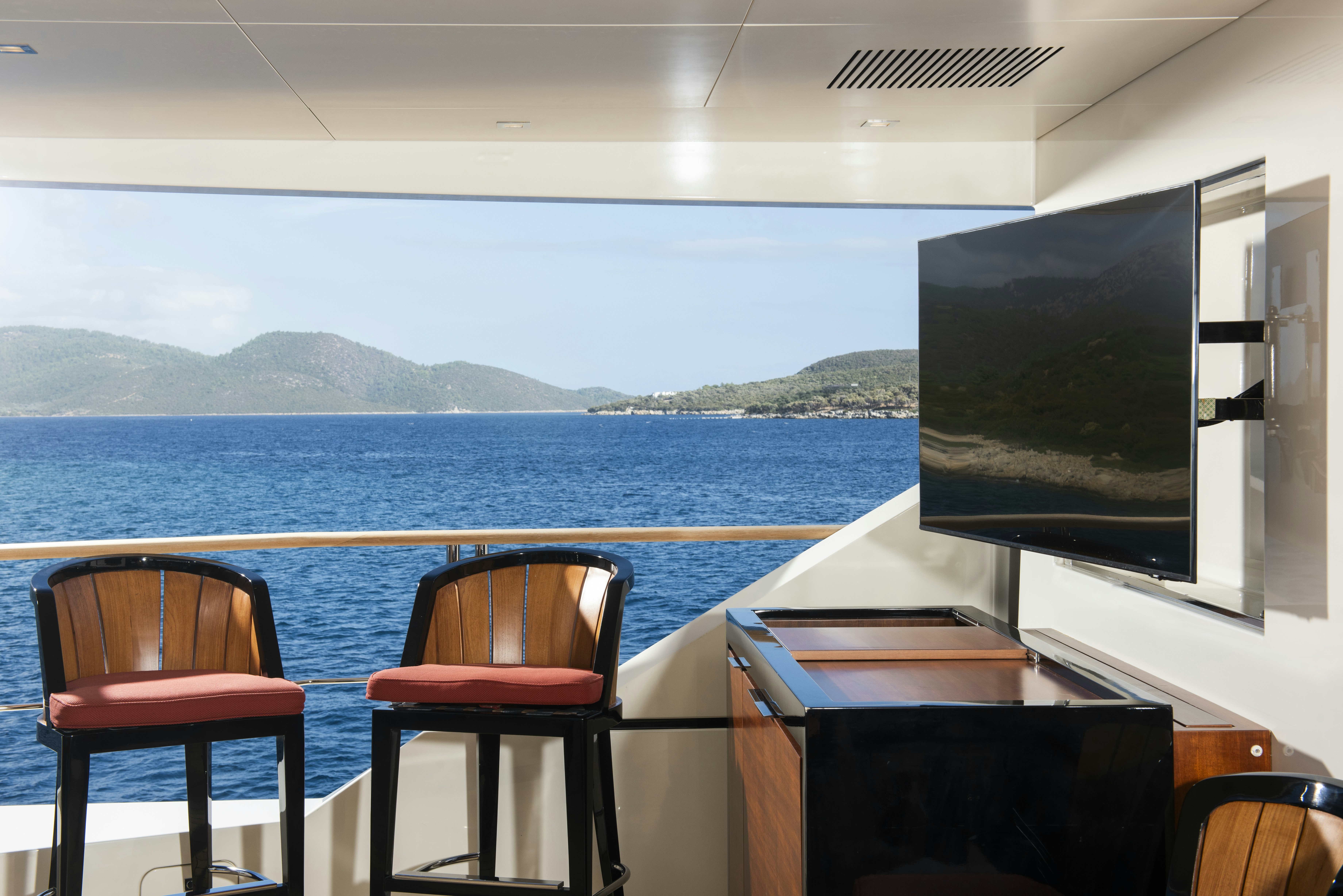 a room with chairs and a tv aboard SERENITY Yacht for Sale