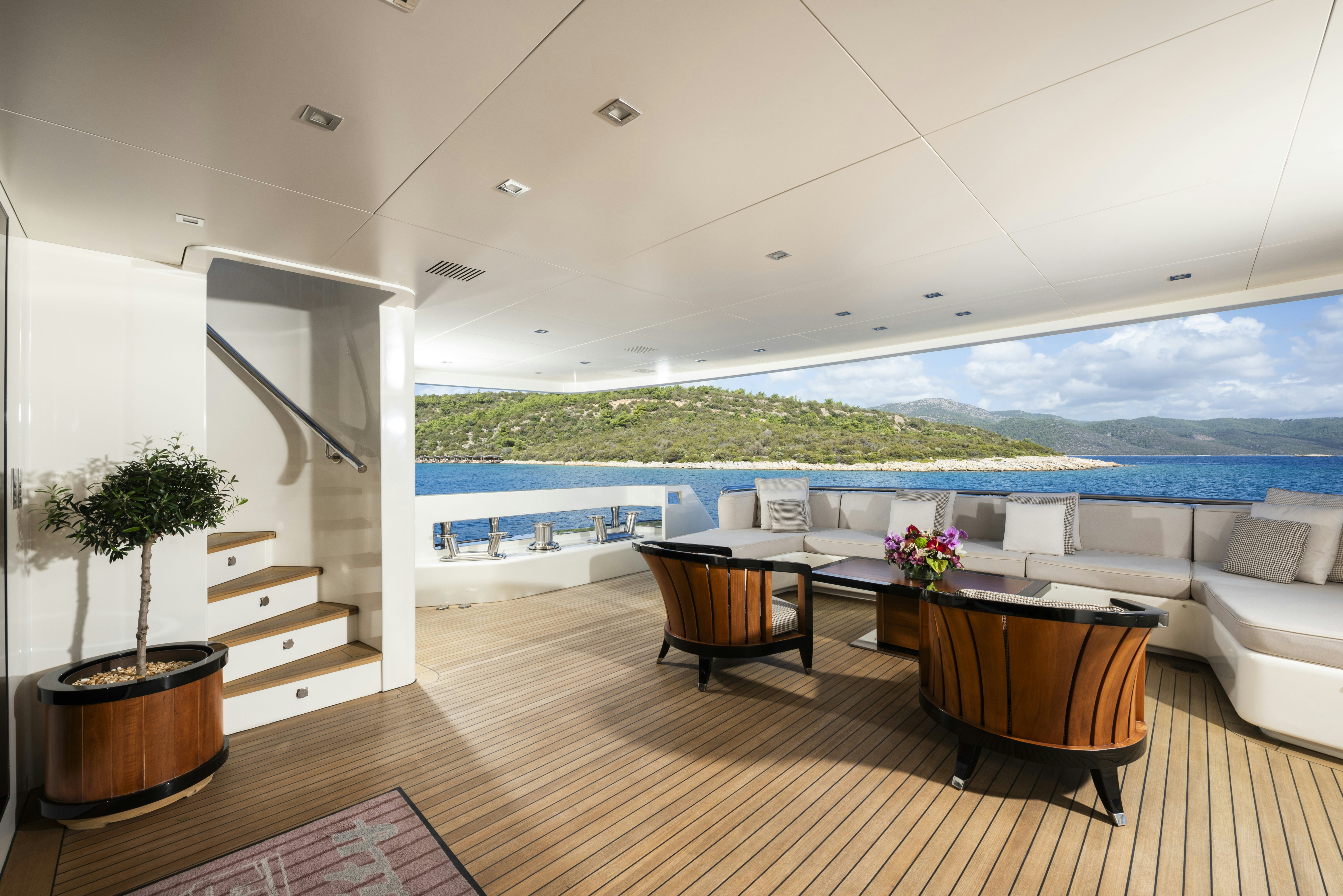 a room with a table and chairs aboard SERENITY Yacht for Sale