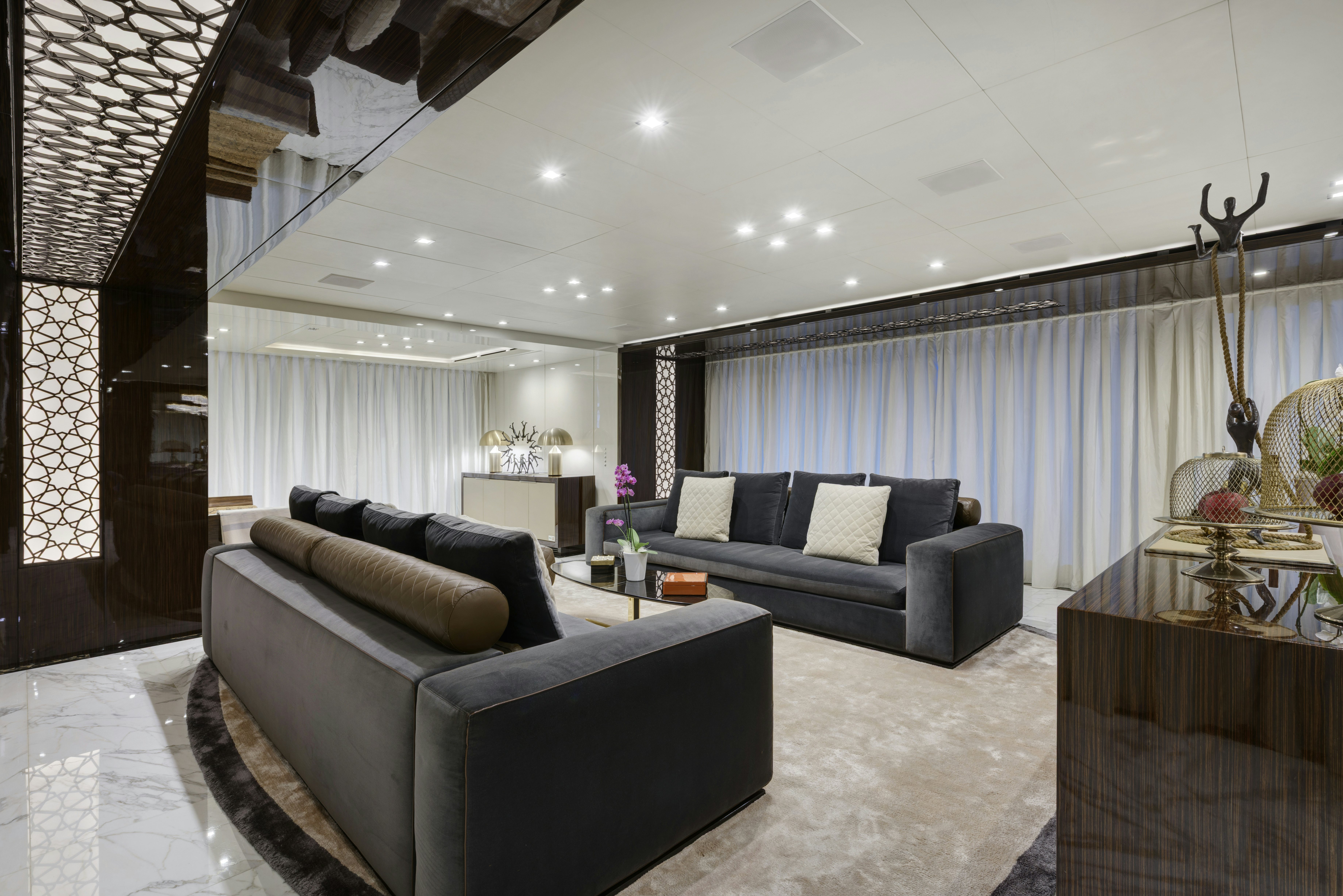 a living room with a couch and a table aboard SERENITY Yacht for Sale