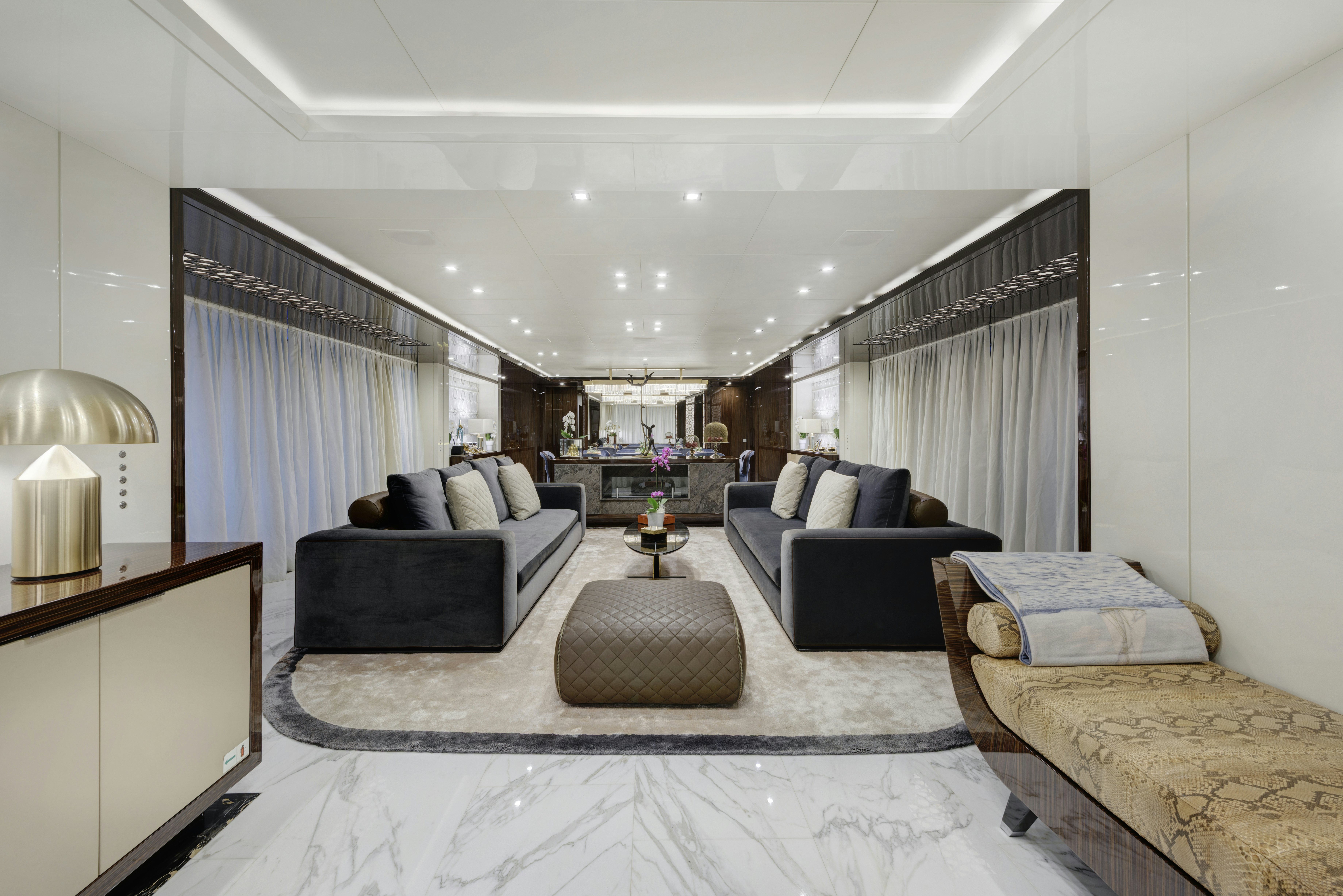 a large living room with a large white rug aboard SERENITY Yacht for Sale