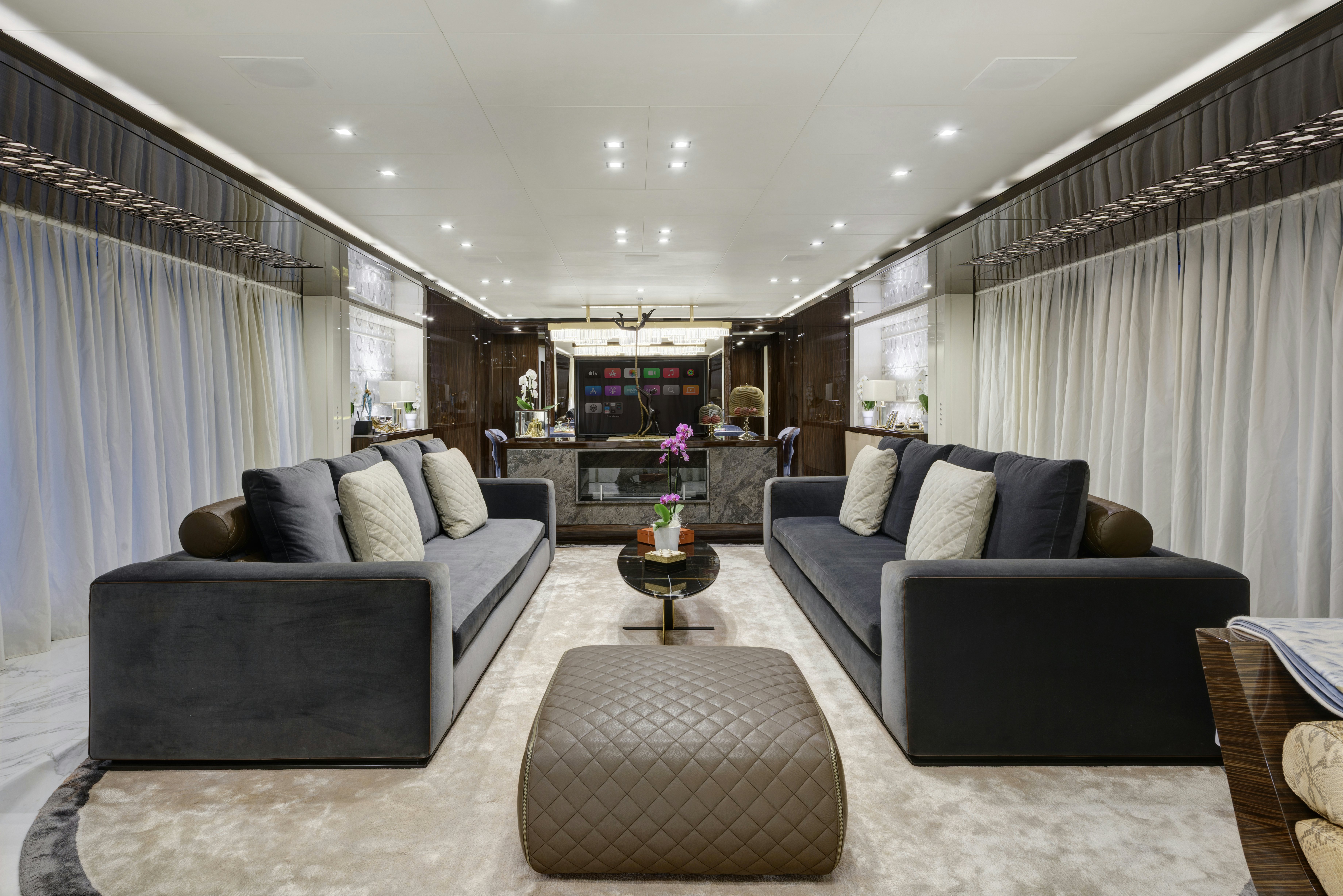 a living room with a couch and a coffee table aboard SERENITY Yacht for Sale