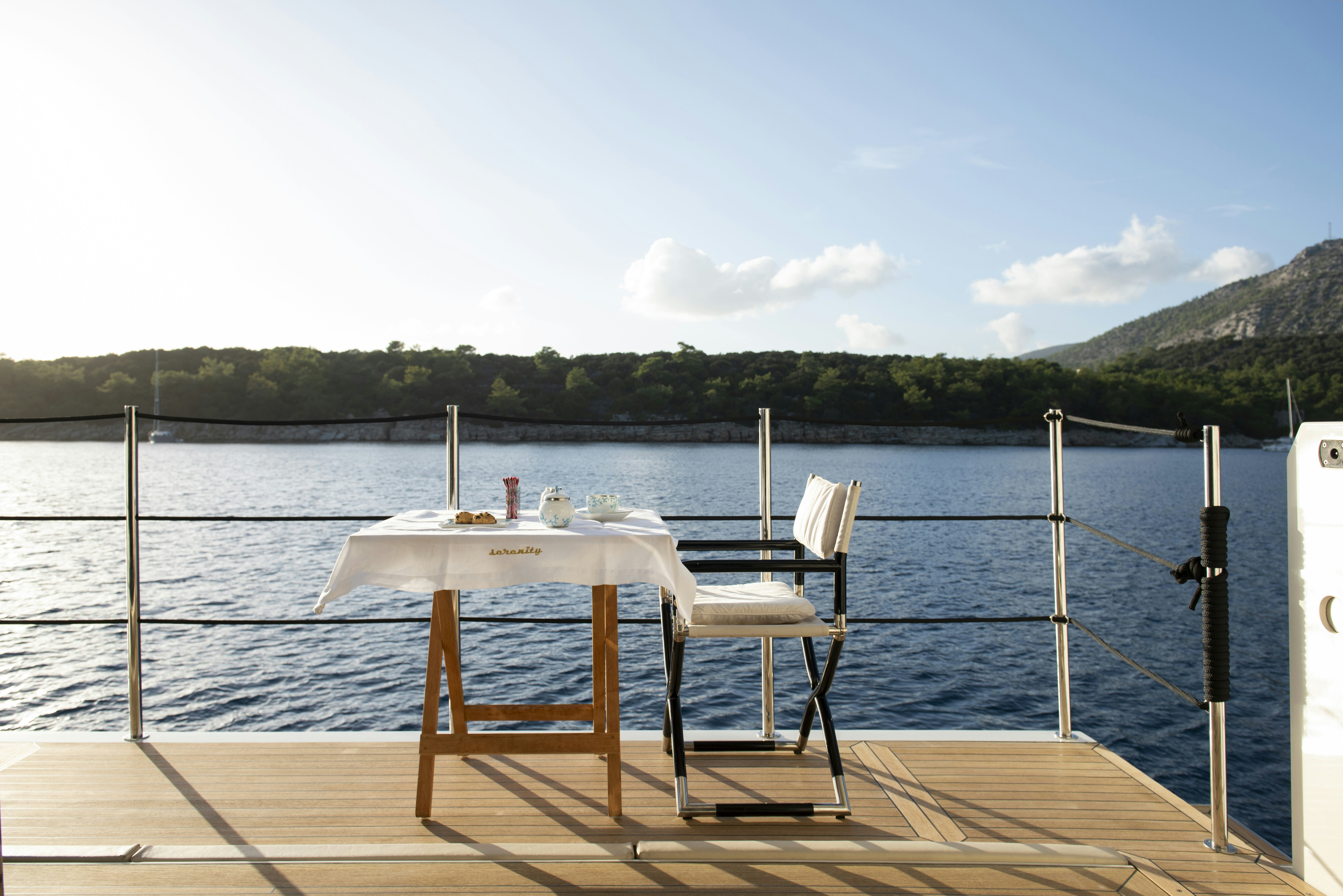 a table and chairs on a dock aboard SERENITY Yacht for Sale