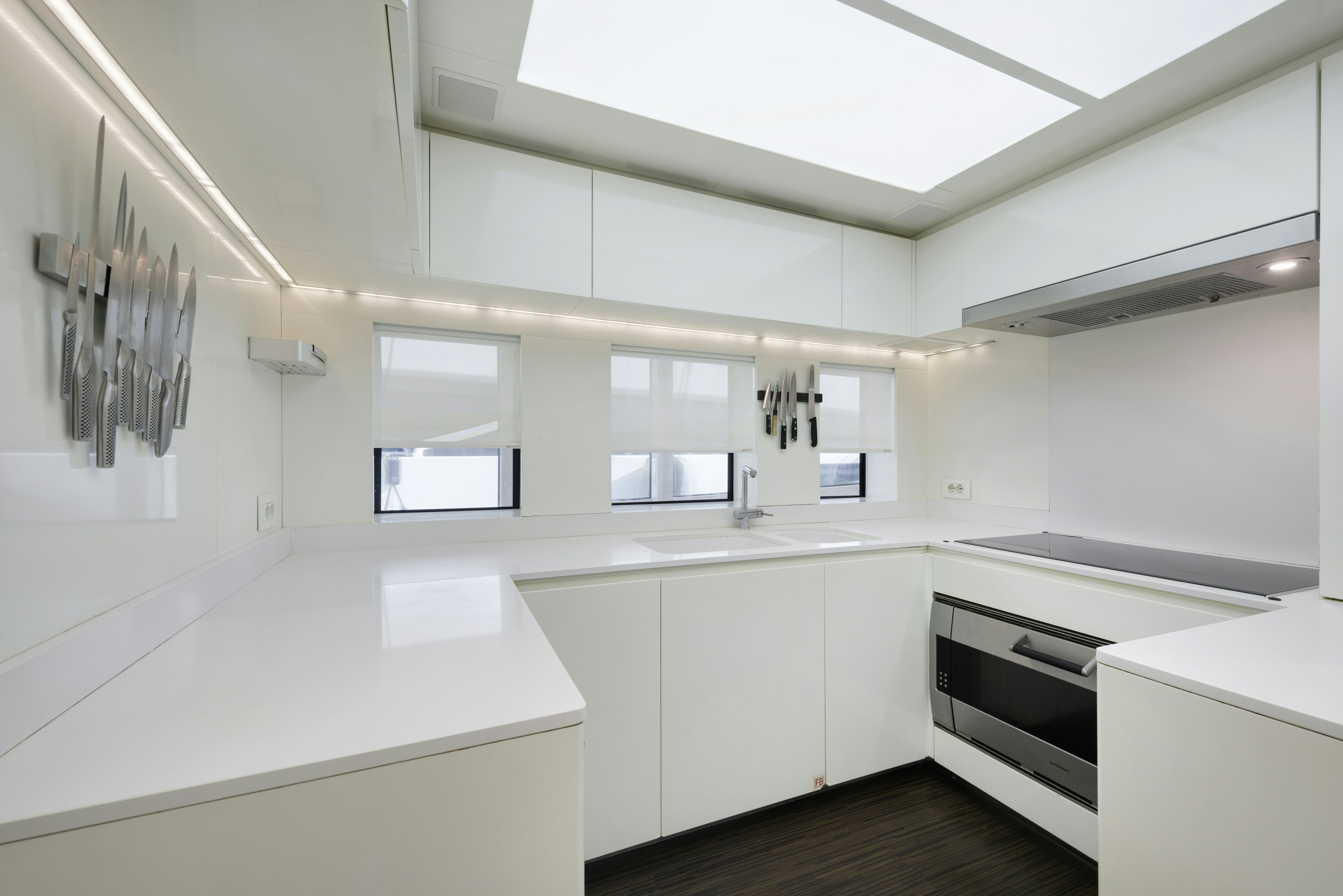 a kitchen with white cabinets aboard SERENITY Yacht for Sale