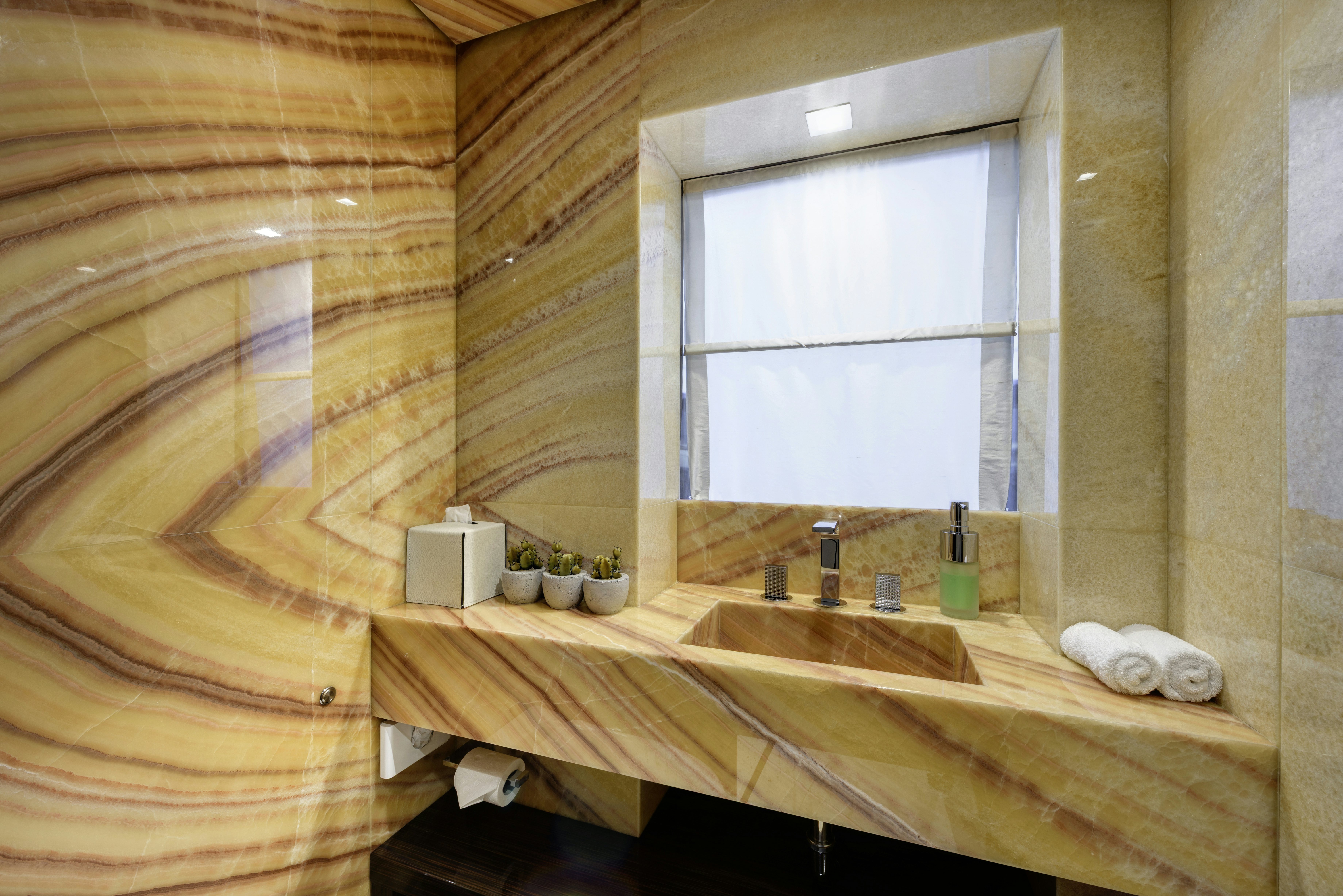 a bathroom with a sink and a window aboard SERENITY Yacht for Sale