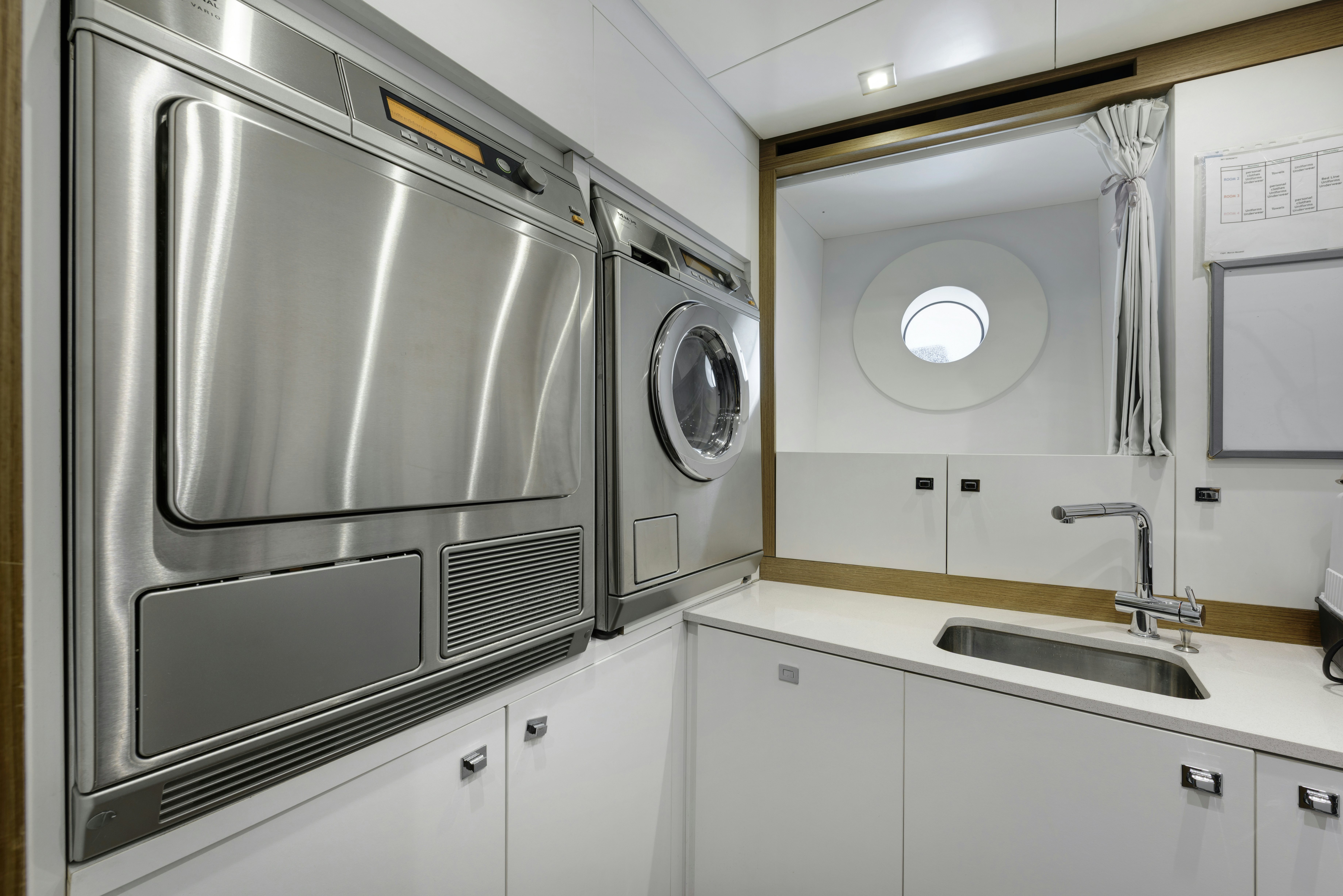 a large washing machine in a kitchen aboard SERENITY Yacht for Sale
