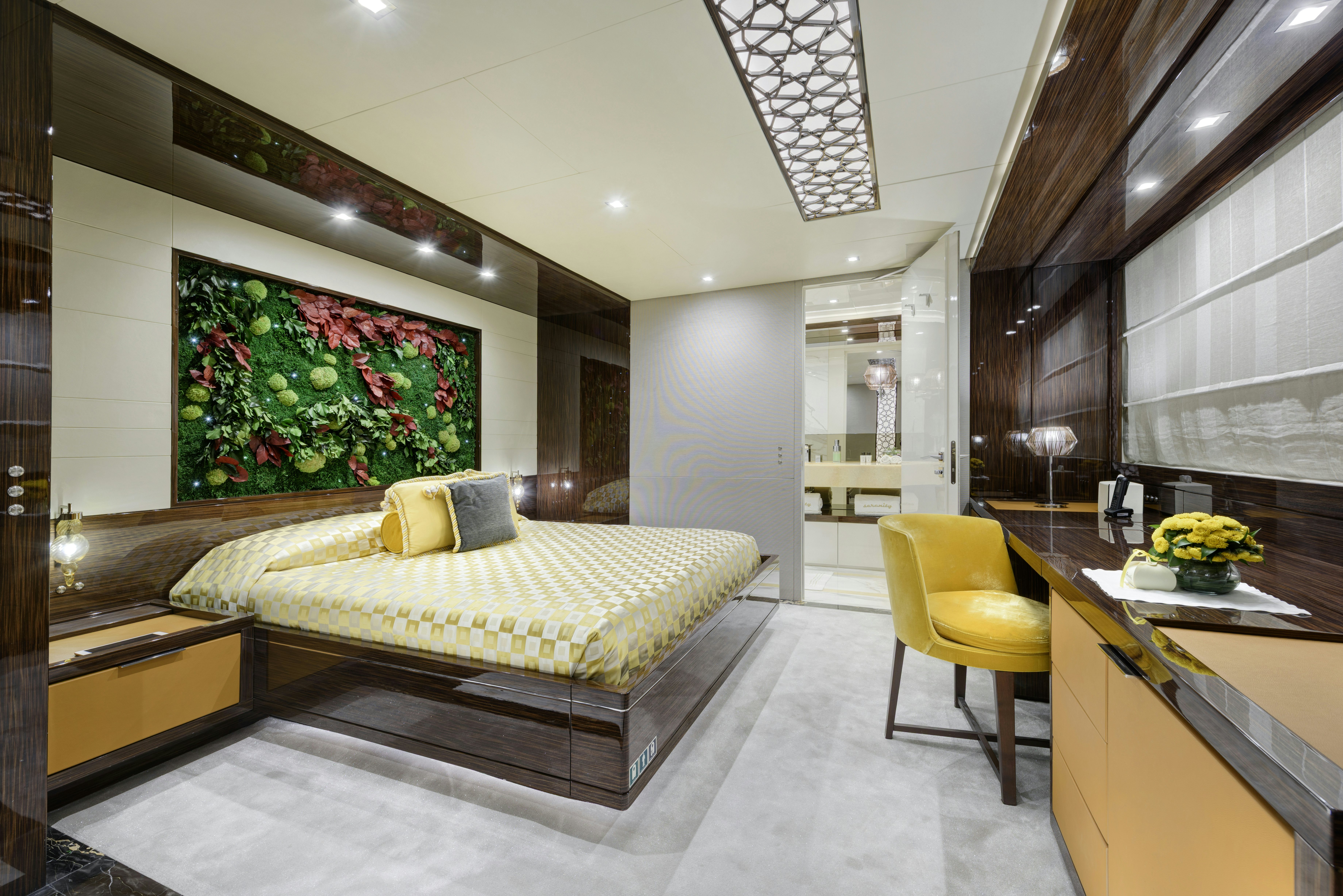 a bedroom with a bed and desk aboard SERENITY Yacht for Sale