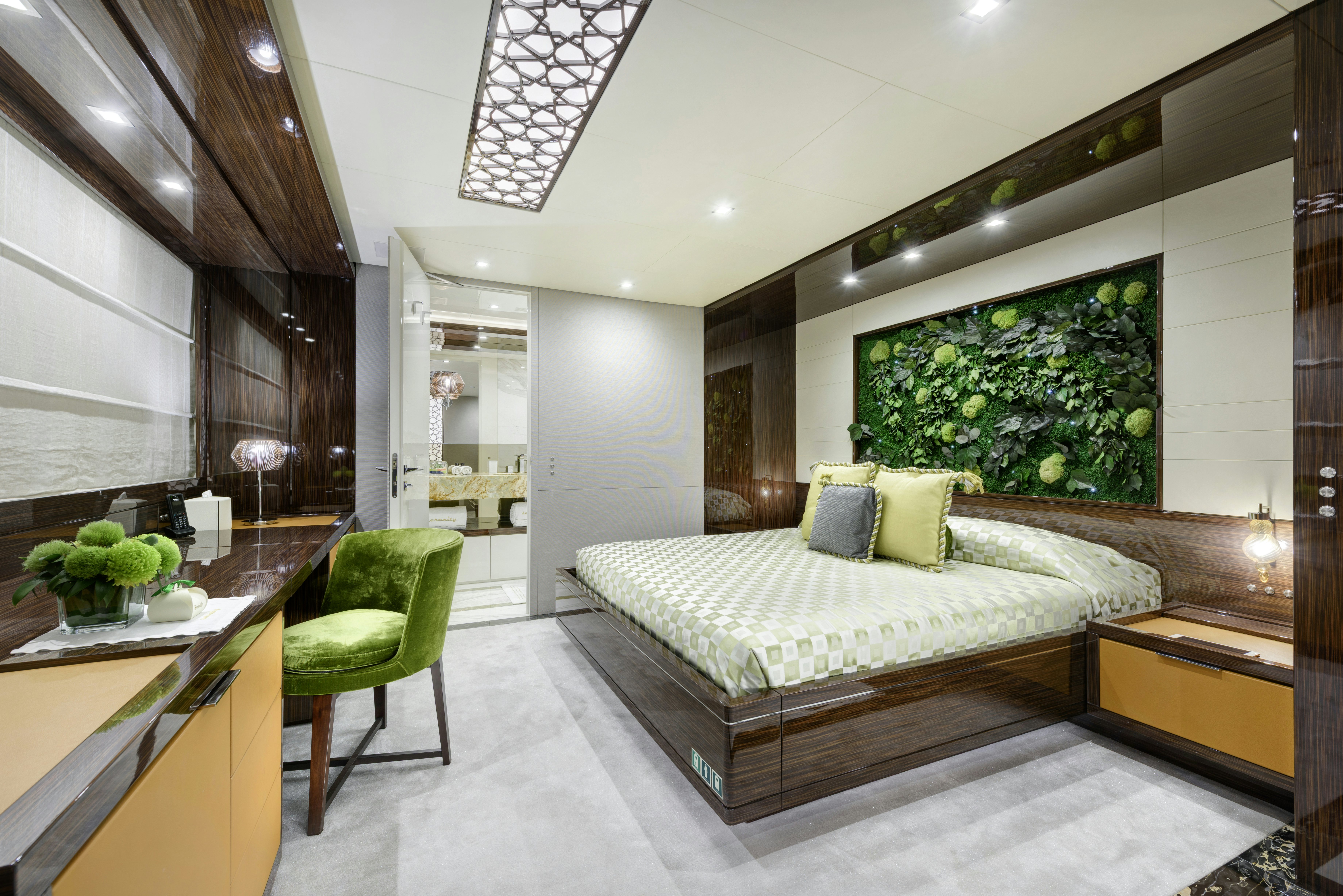 a bedroom with a bed and a desk aboard SERENITY Yacht for Sale