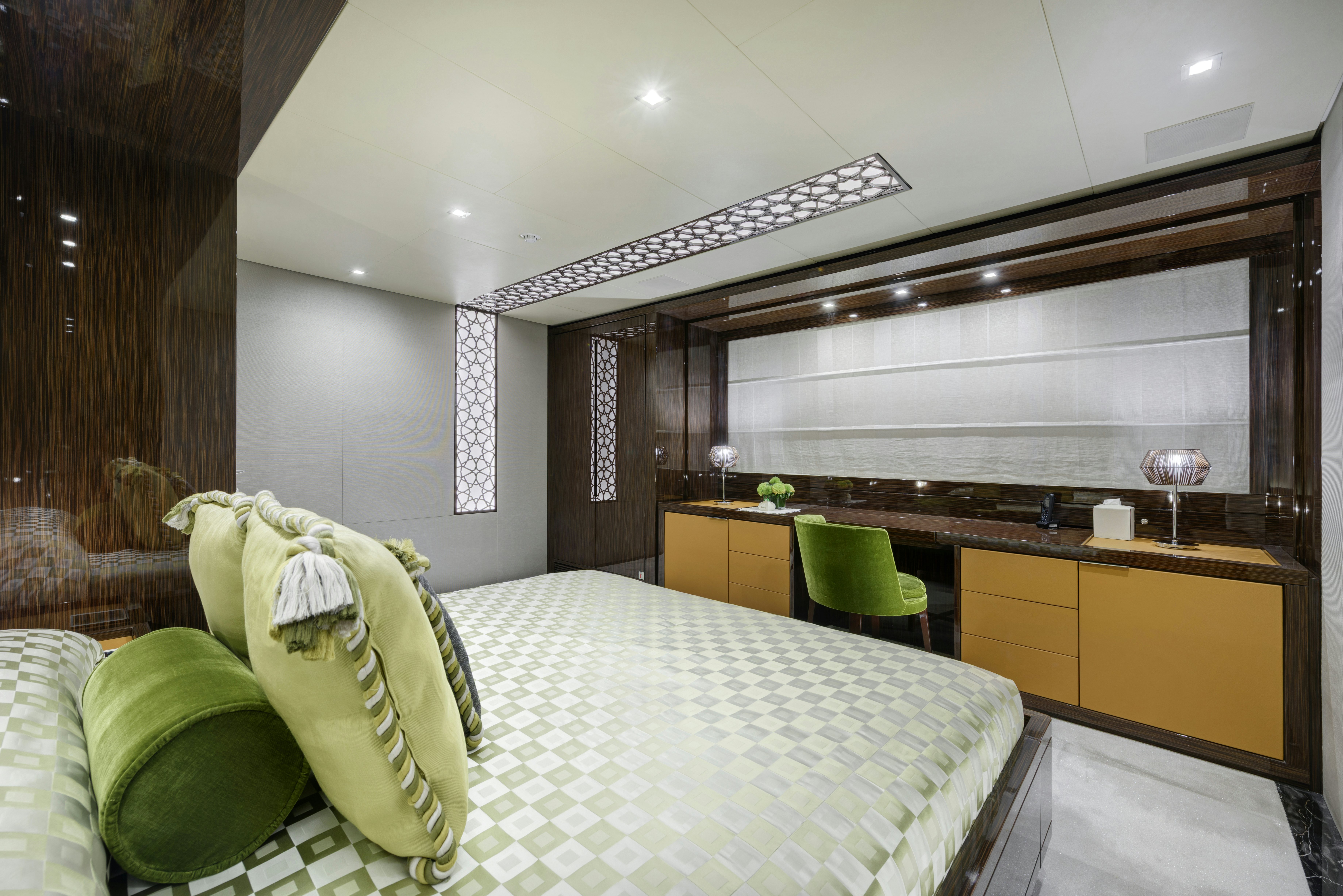 a room with a bed and a desk aboard SERENITY Yacht for Sale