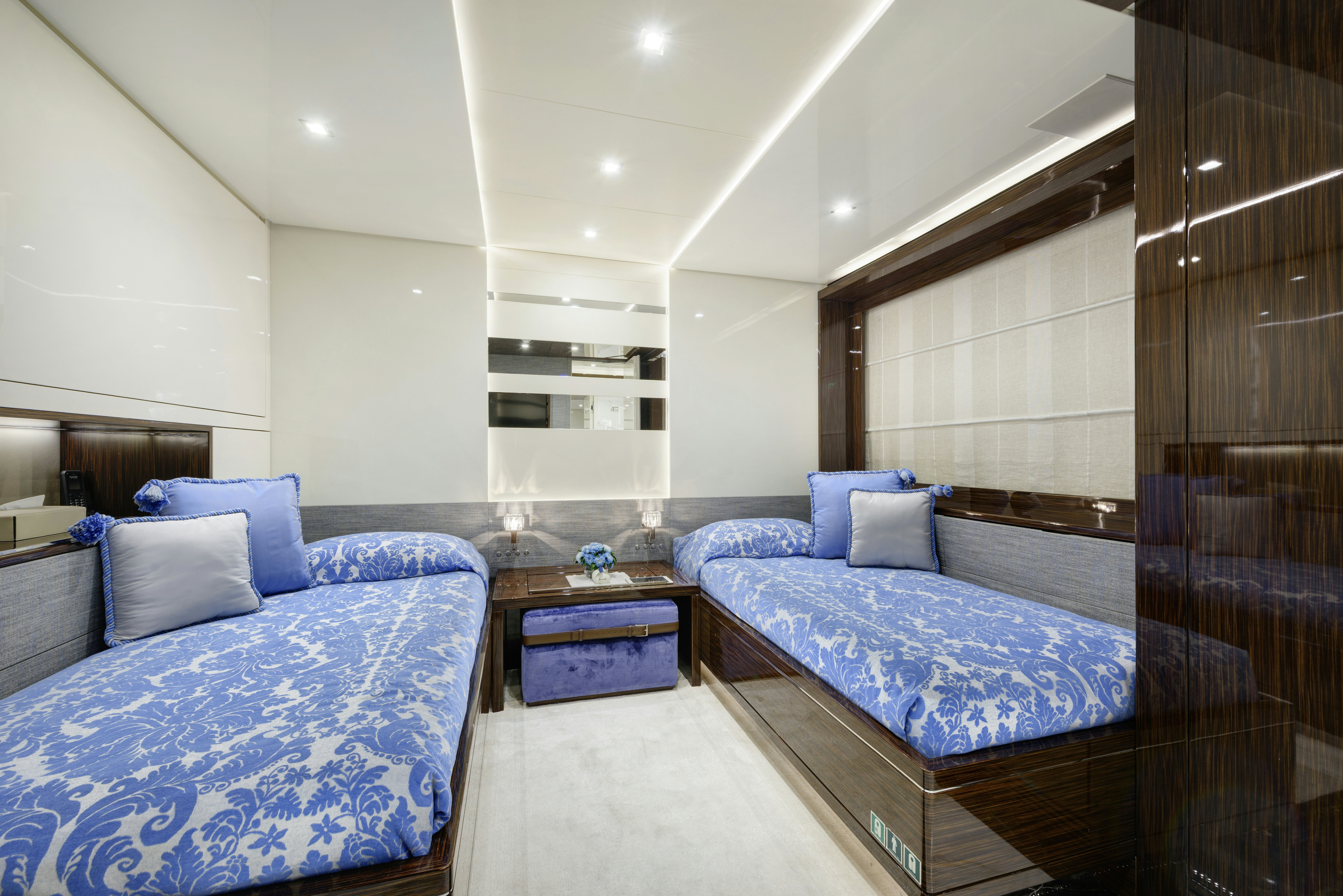 a room with a bed and a desk aboard SERENITY Yacht for Sale