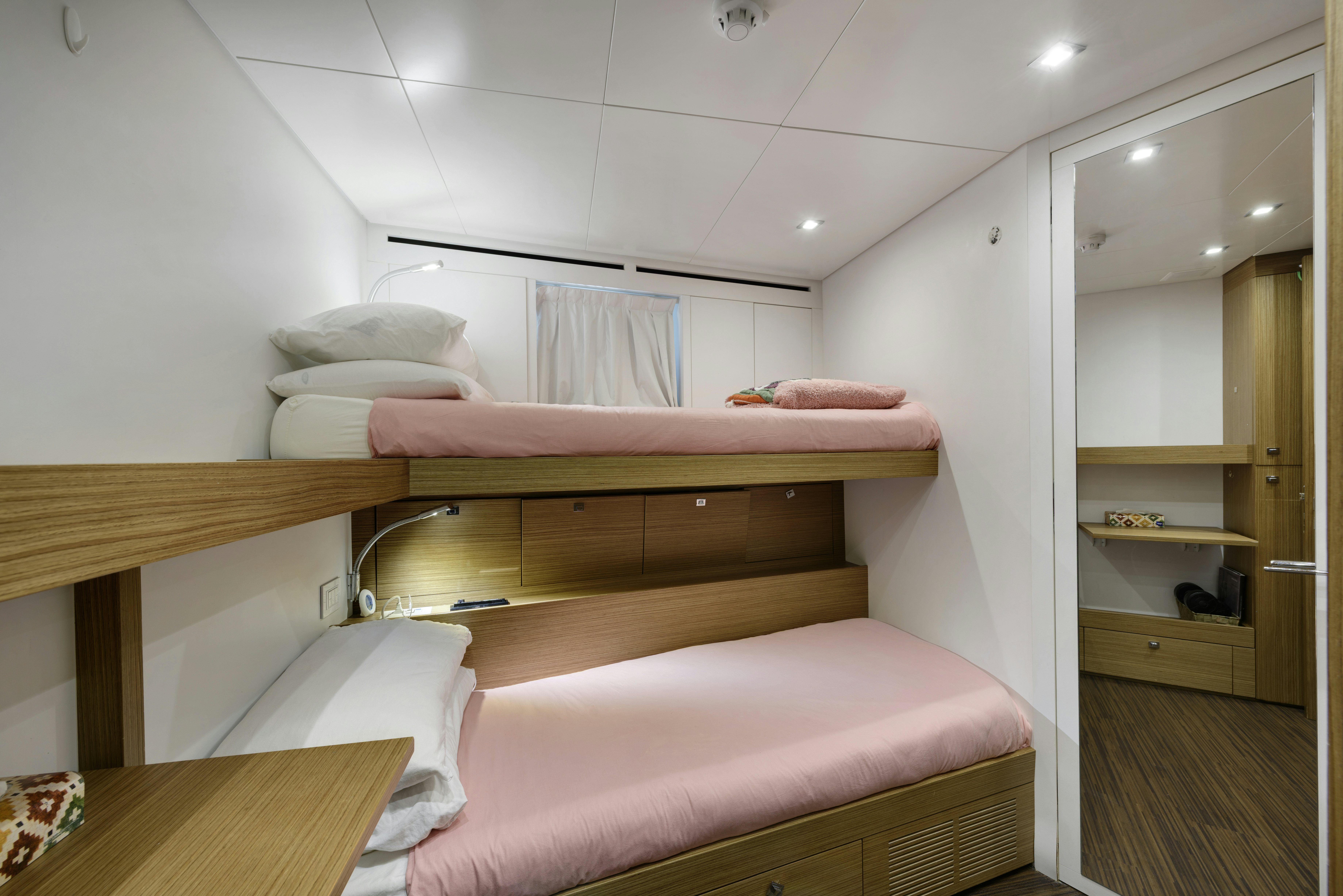 a room with a bed and a table aboard SERENITY Yacht for Sale