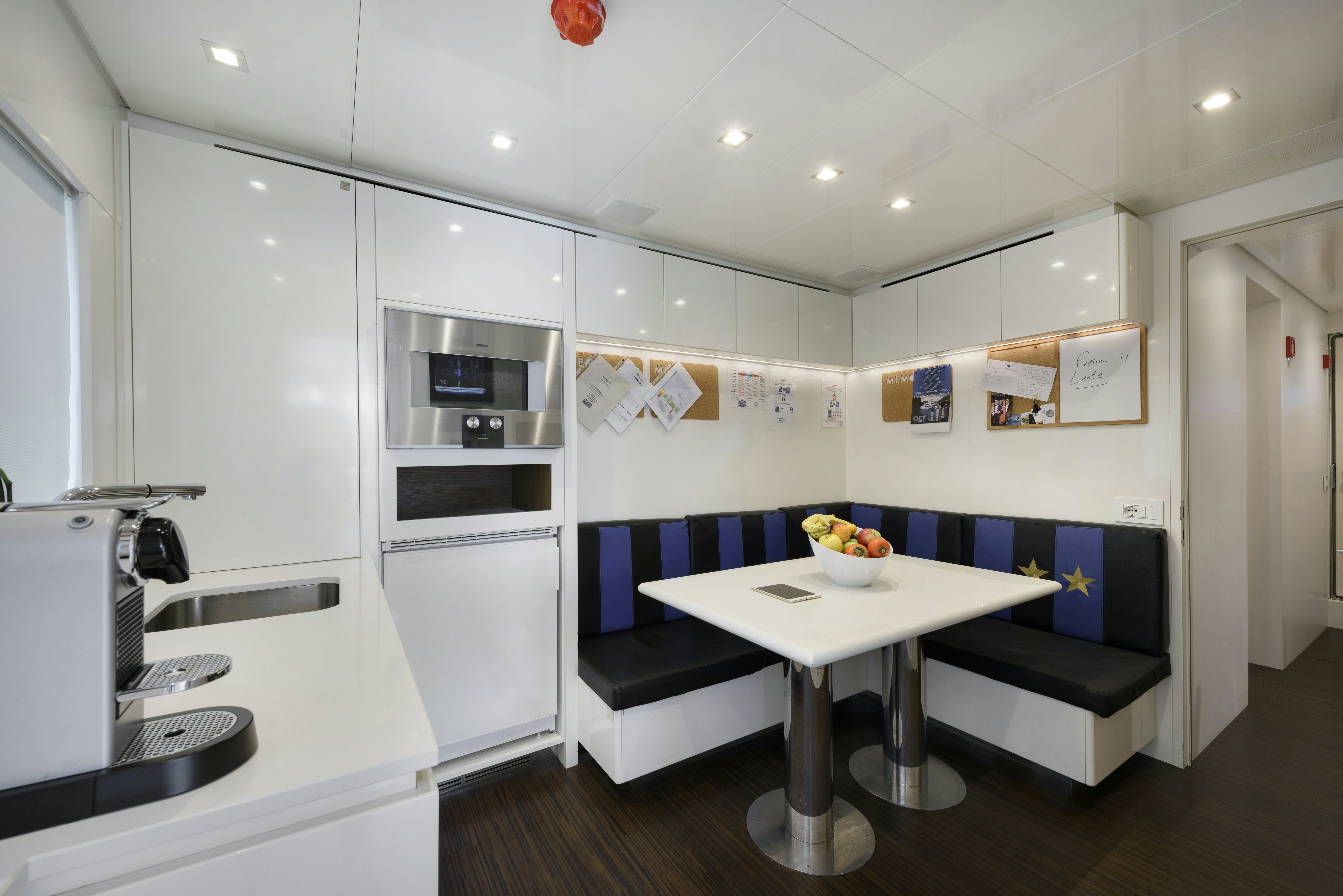 a kitchen with white cabinets aboard SERENITY Yacht for Sale