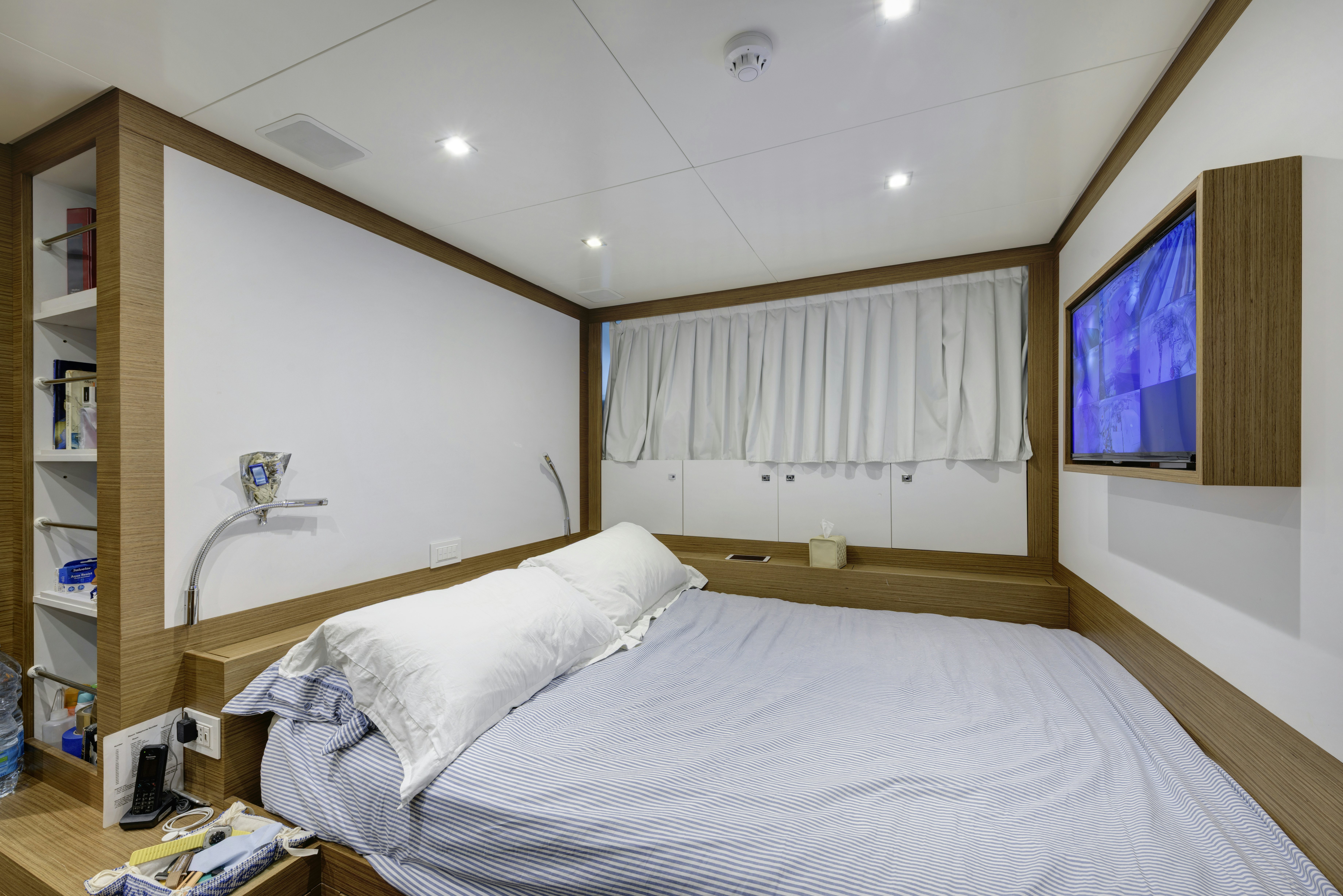 a bedroom with a large bed aboard SERENITY Yacht for Sale