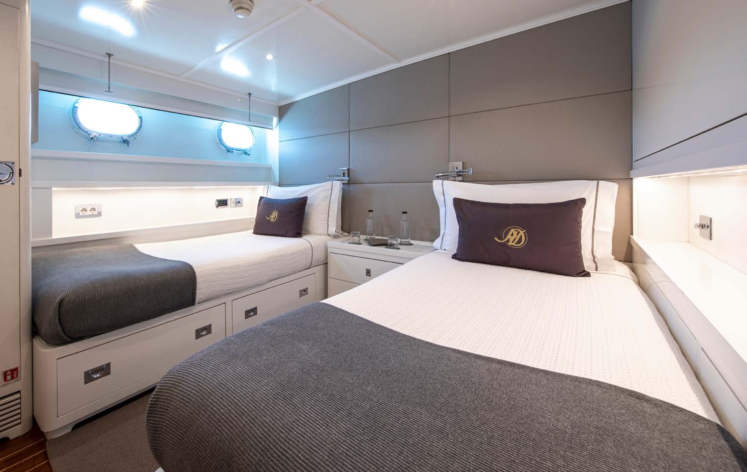 a room with a bed and a desk aboard HEAVENLY DAZE Yacht for Charter