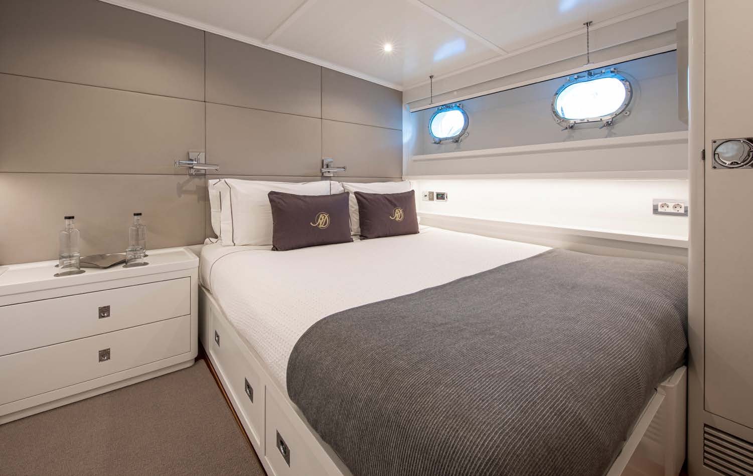 a bedroom with a bed and a sink aboard HEAVENLY DAZE Yacht for Charter