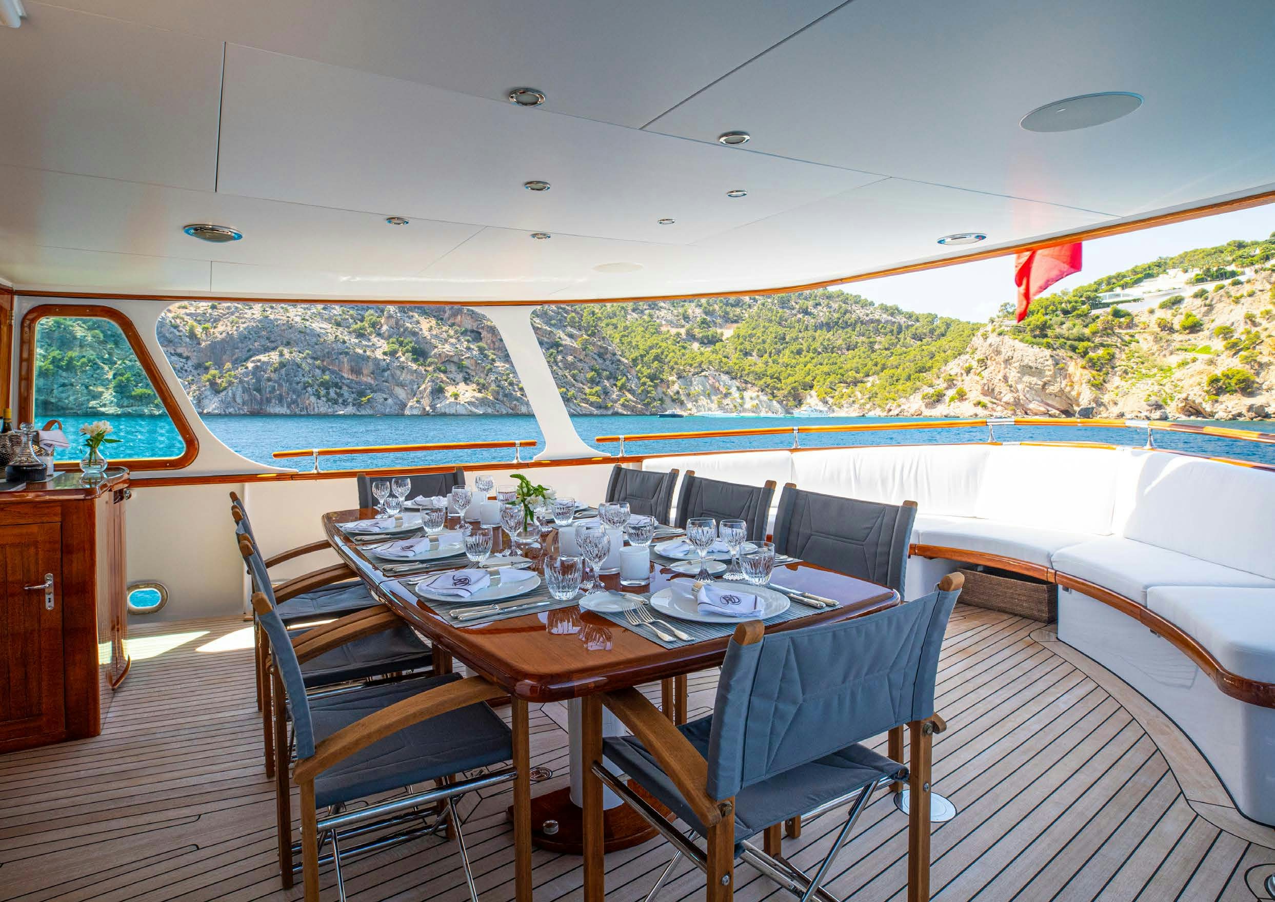 a dining table on a deck aboard HEAVENLY DAZE Yacht for Charter
