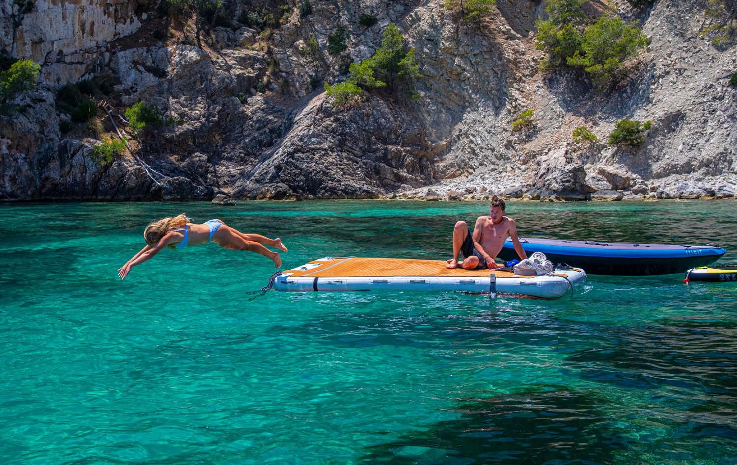a couple of people in a body of water with boats aboard HEAVENLY DAZE Yacht for Charter