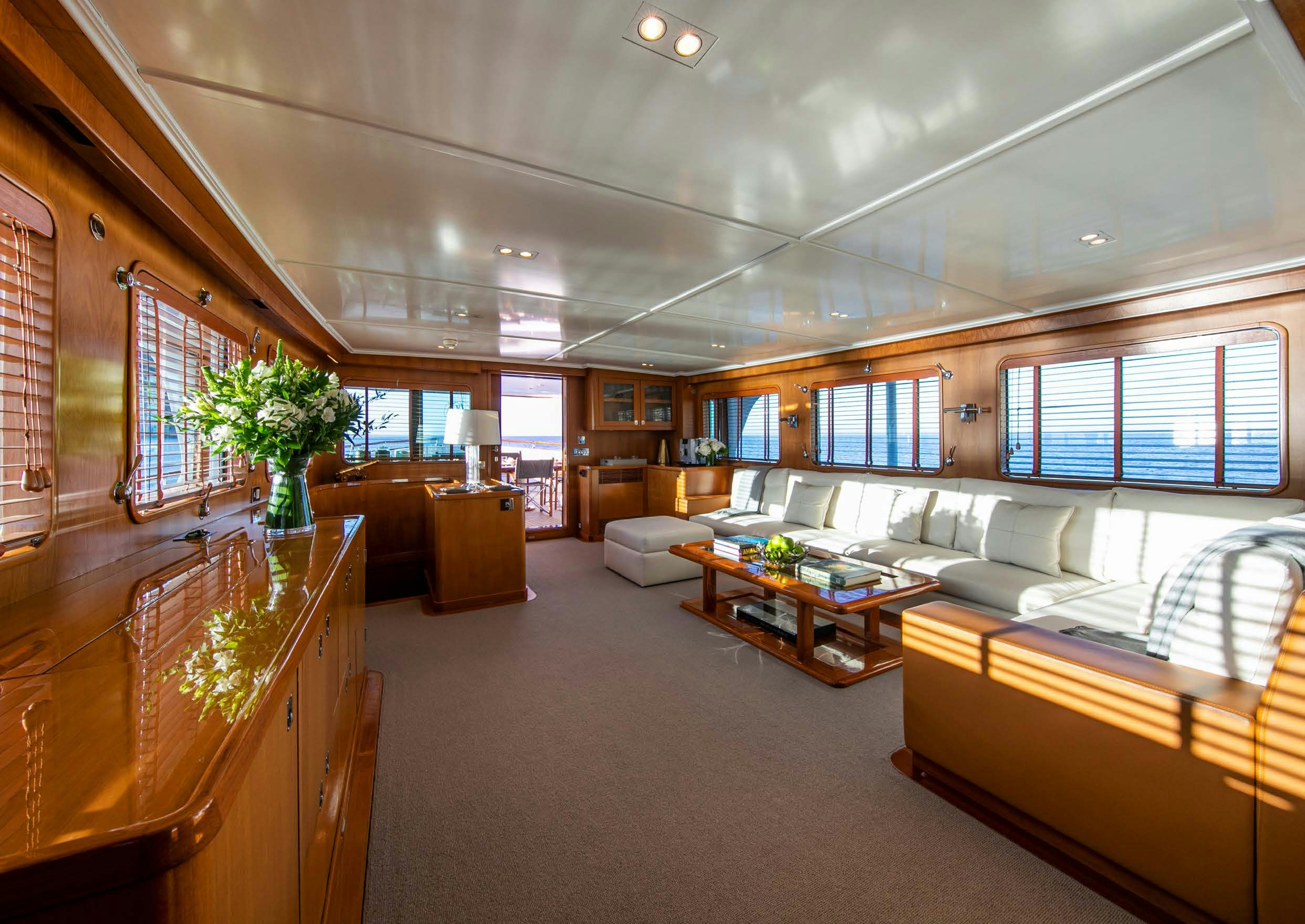 a large living room with a large window aboard HEAVENLY DAZE Yacht for Charter