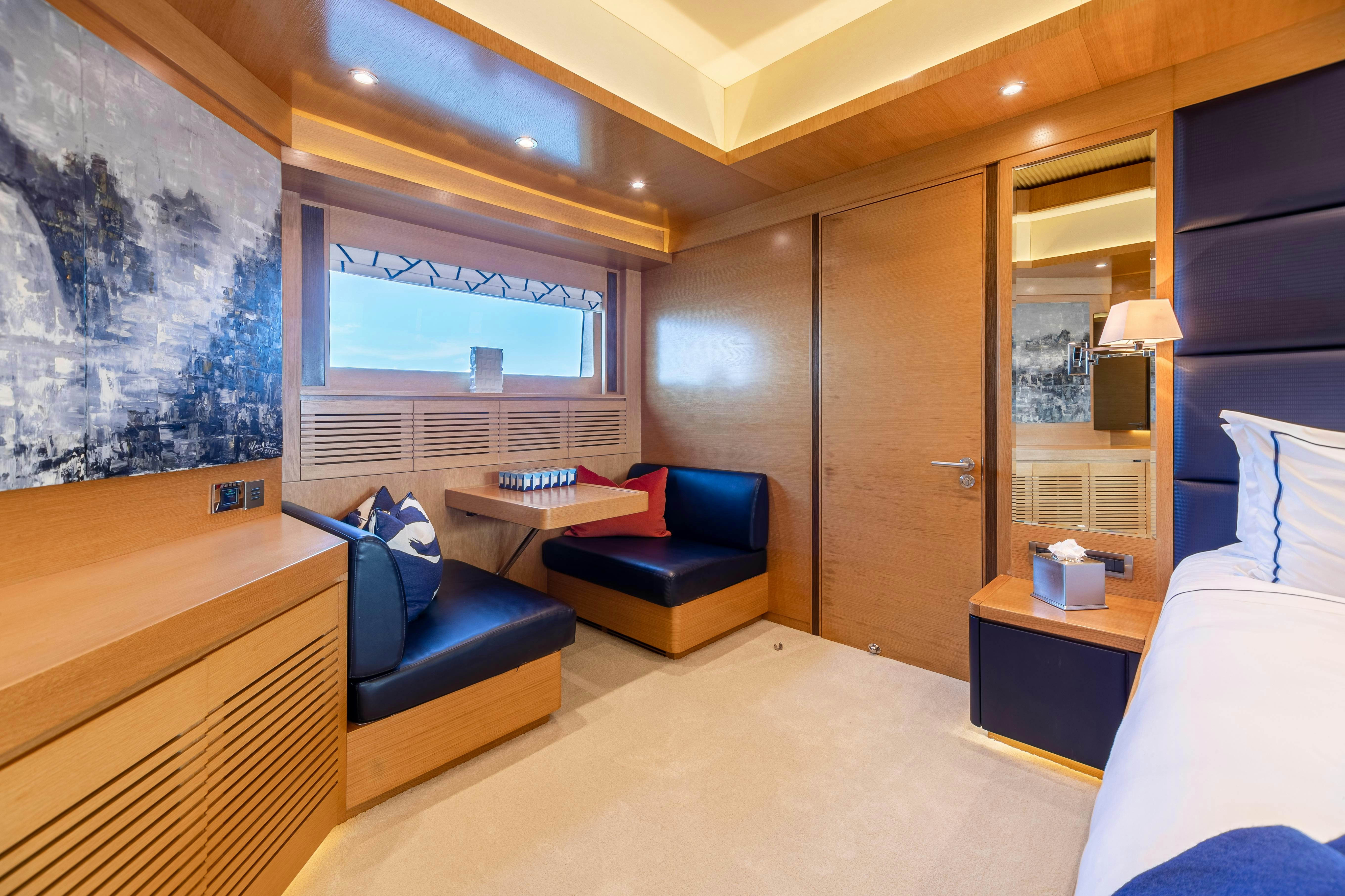 a room with a bed and a couch aboard SWEET CAROLINE Yacht for Charter