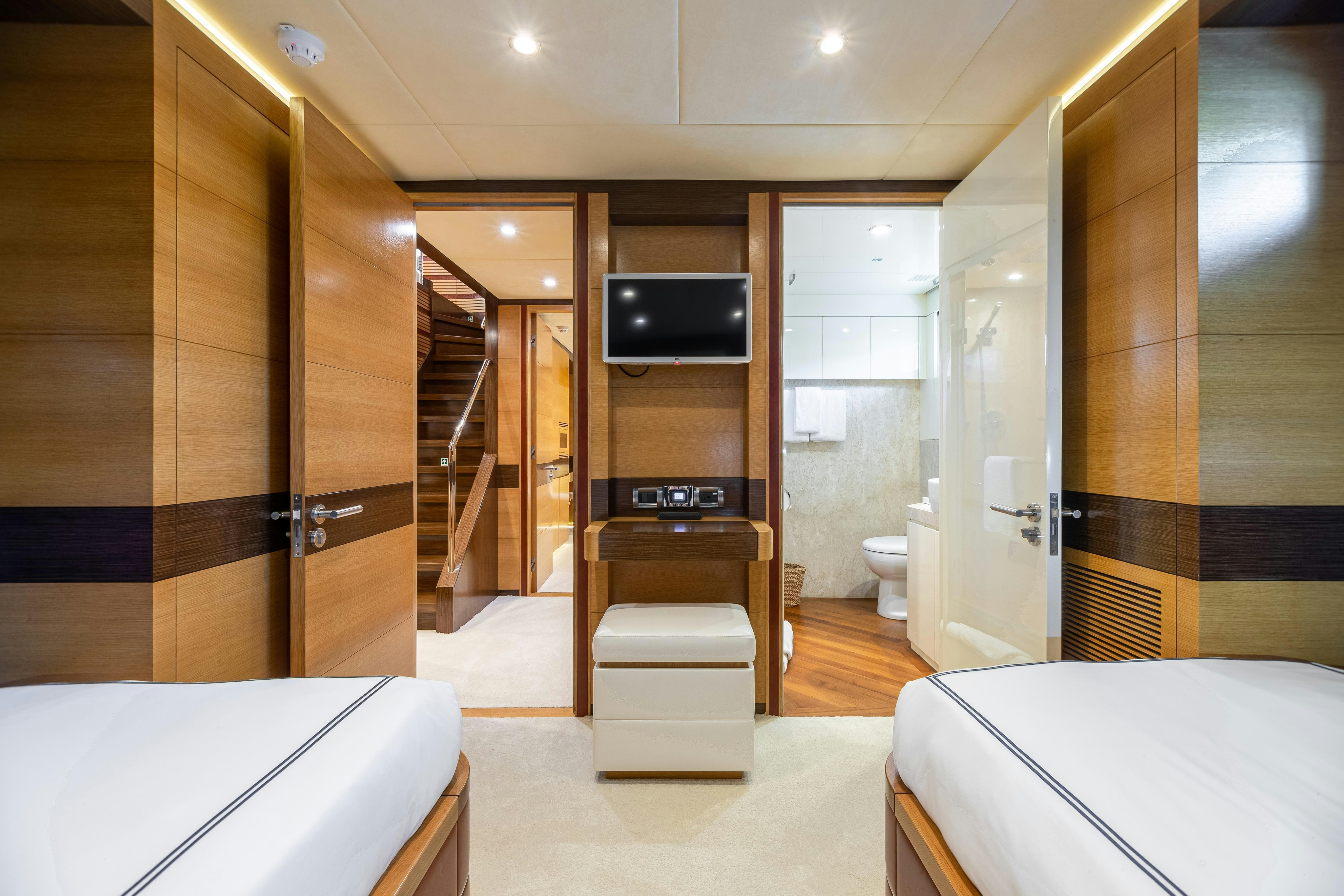 a room with a bed and a tv aboard SWEET CAROLINE Yacht for Charter