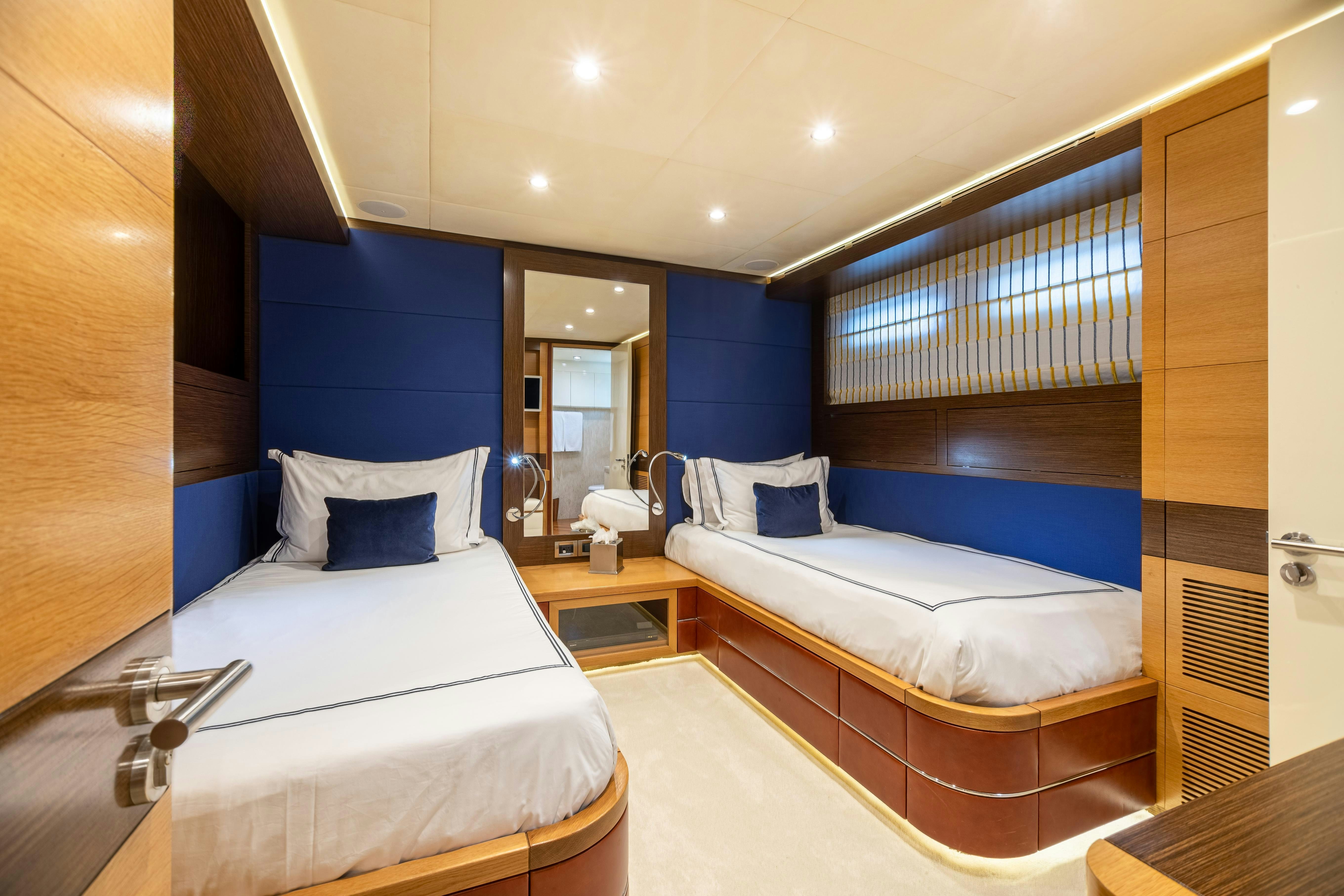 a room with a couple beds aboard SWEET CAROLINE Yacht for Charter