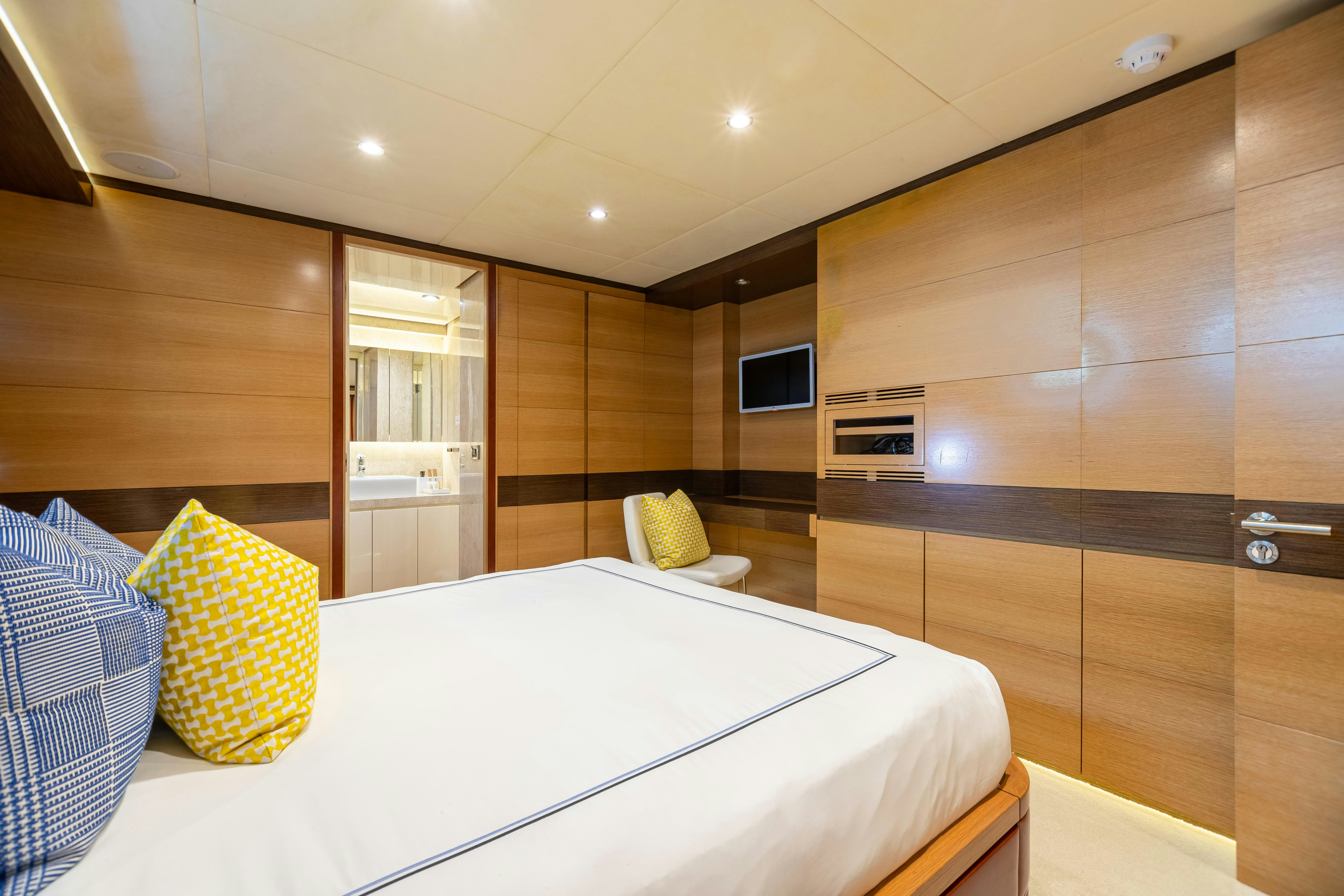 a room with a bed and a mirror aboard SWEET CAROLINE Yacht for Charter