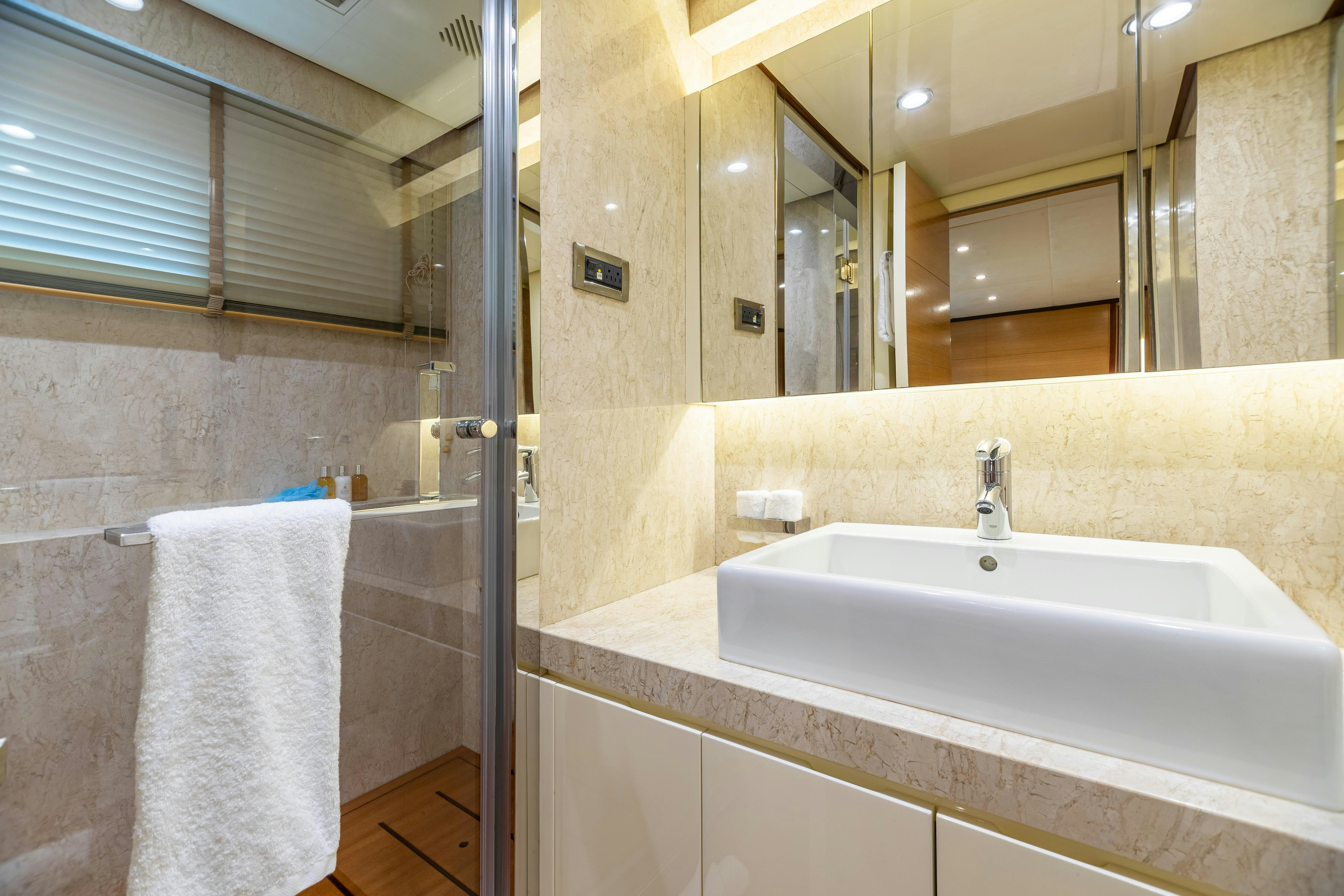 a bathroom with a sink and a mirror aboard SWEET CAROLINE Yacht for Charter