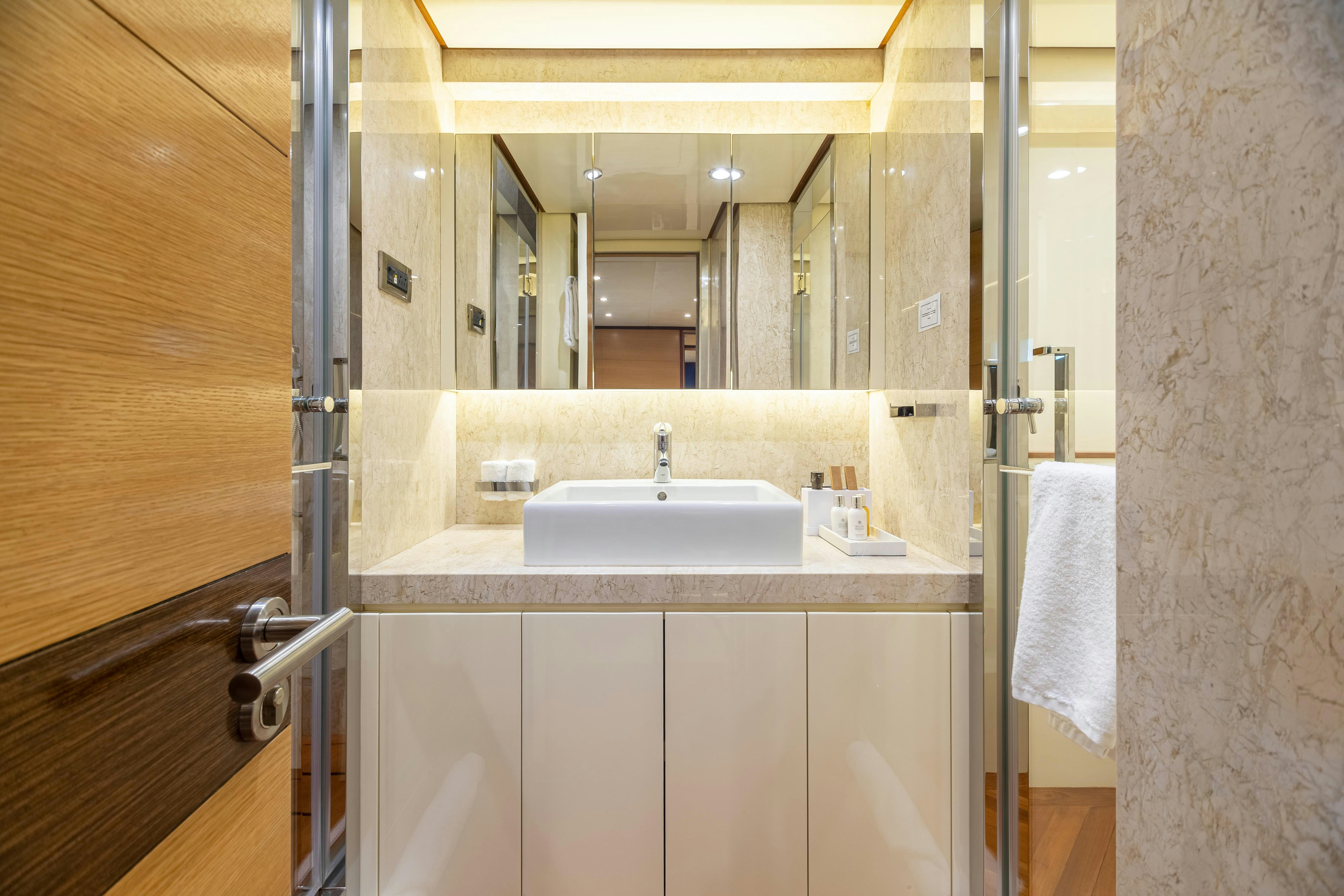 a bathroom with a sink and mirror aboard SWEET CAROLINE Yacht for Charter