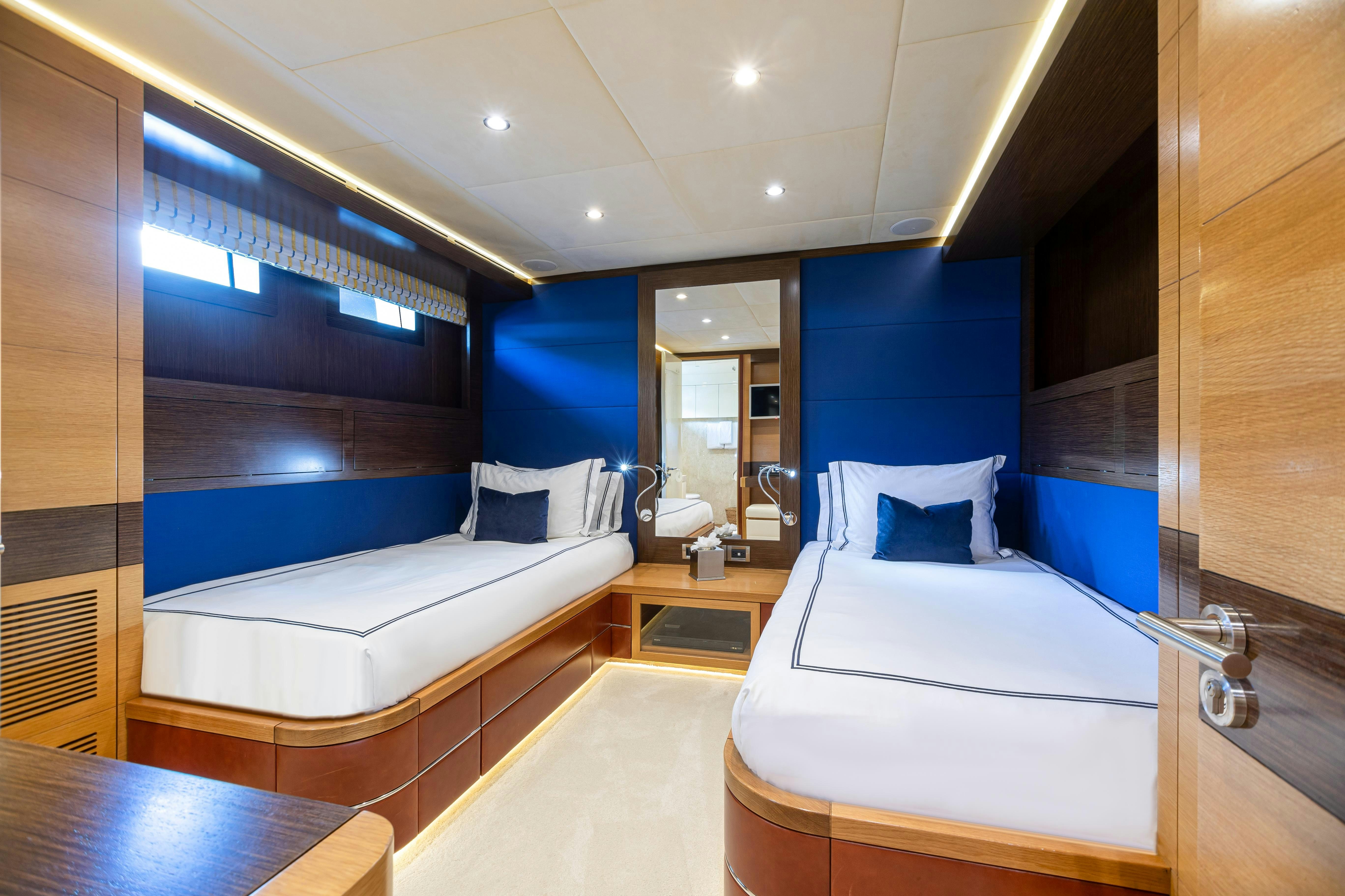 a room with a bed and a mirror aboard SWEET CAROLINE Yacht for Charter