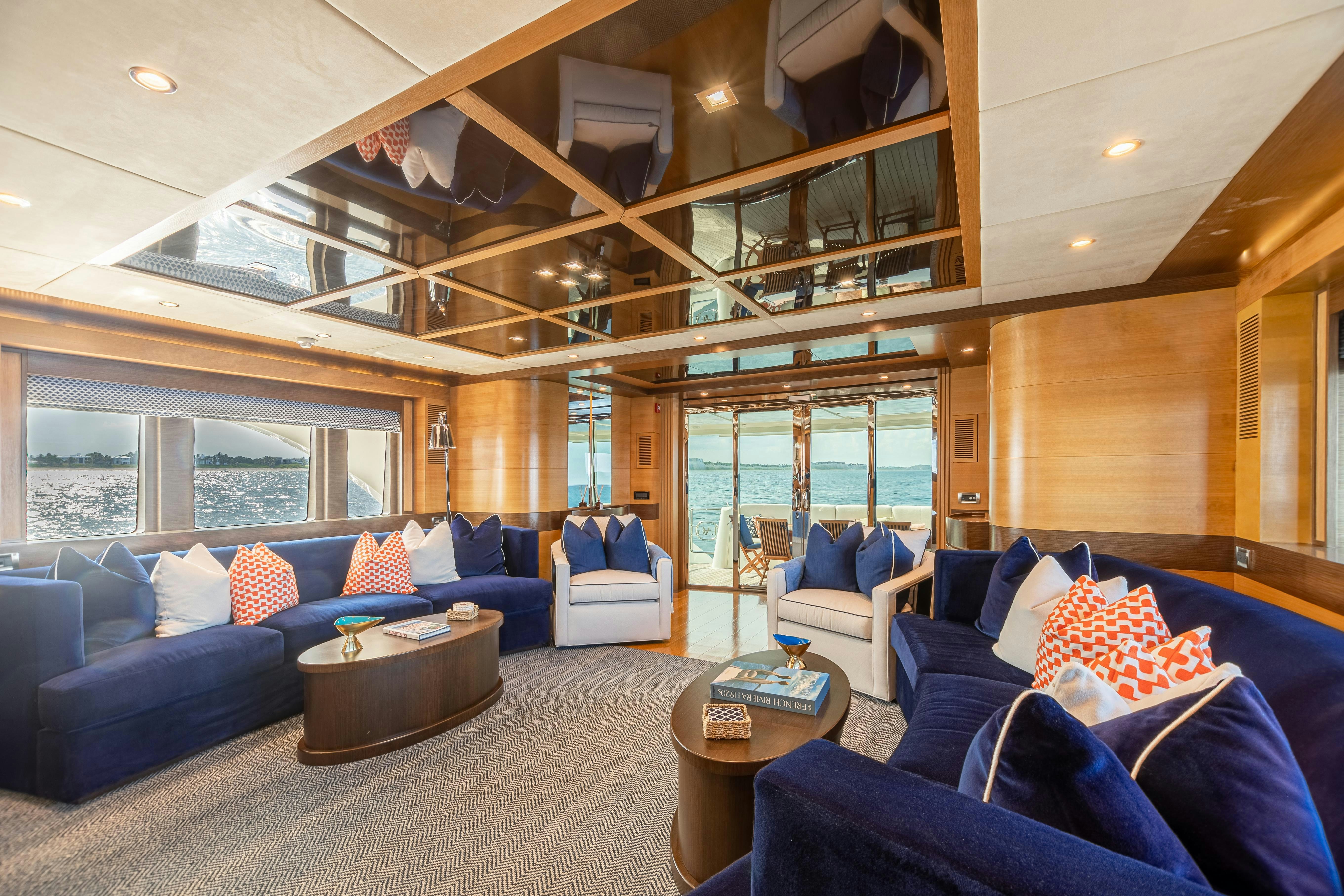 a living room with a large window aboard SWEET CAROLINE Yacht for Charter