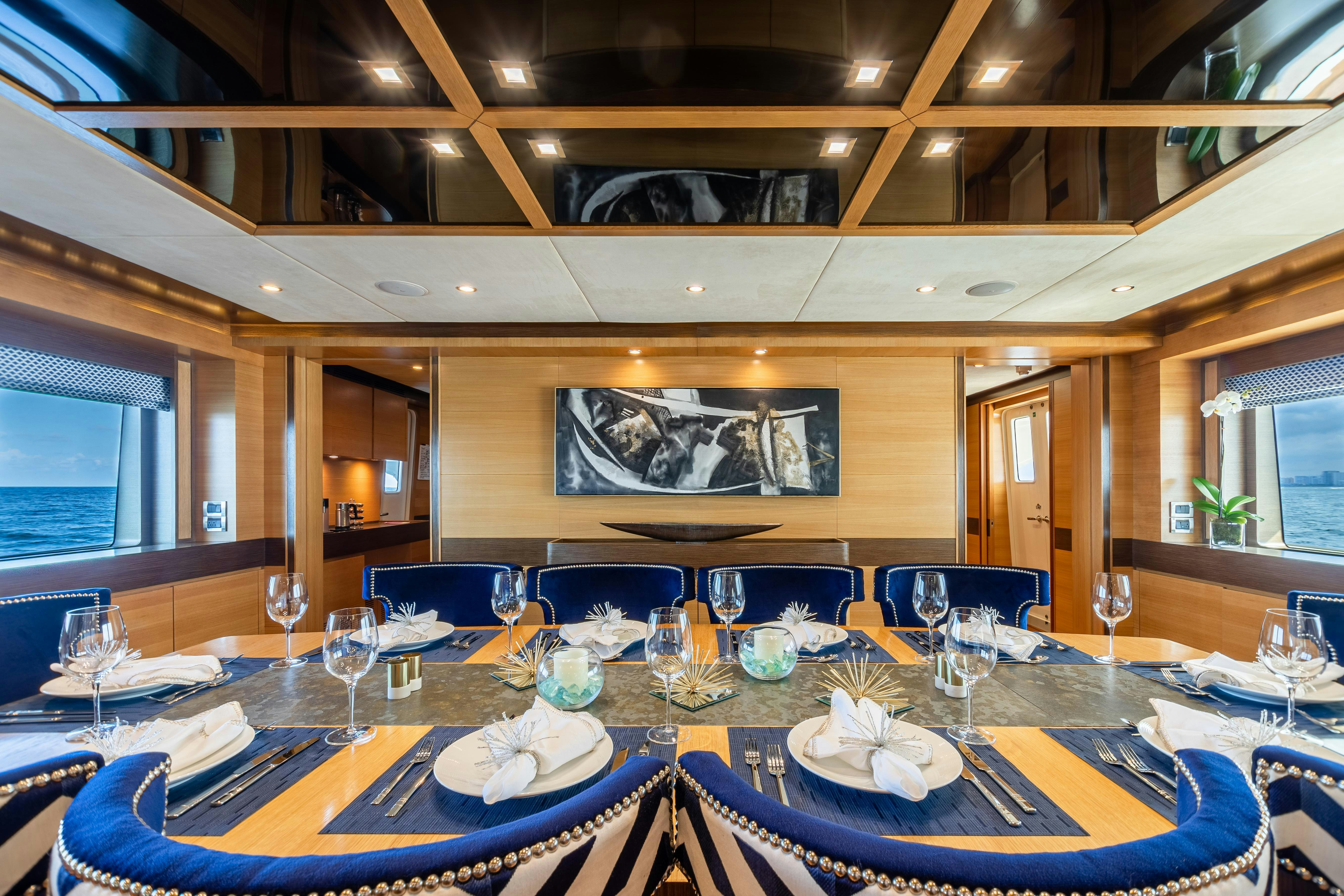 a dining room with a table set aboard SWEET CAROLINE Yacht for Charter