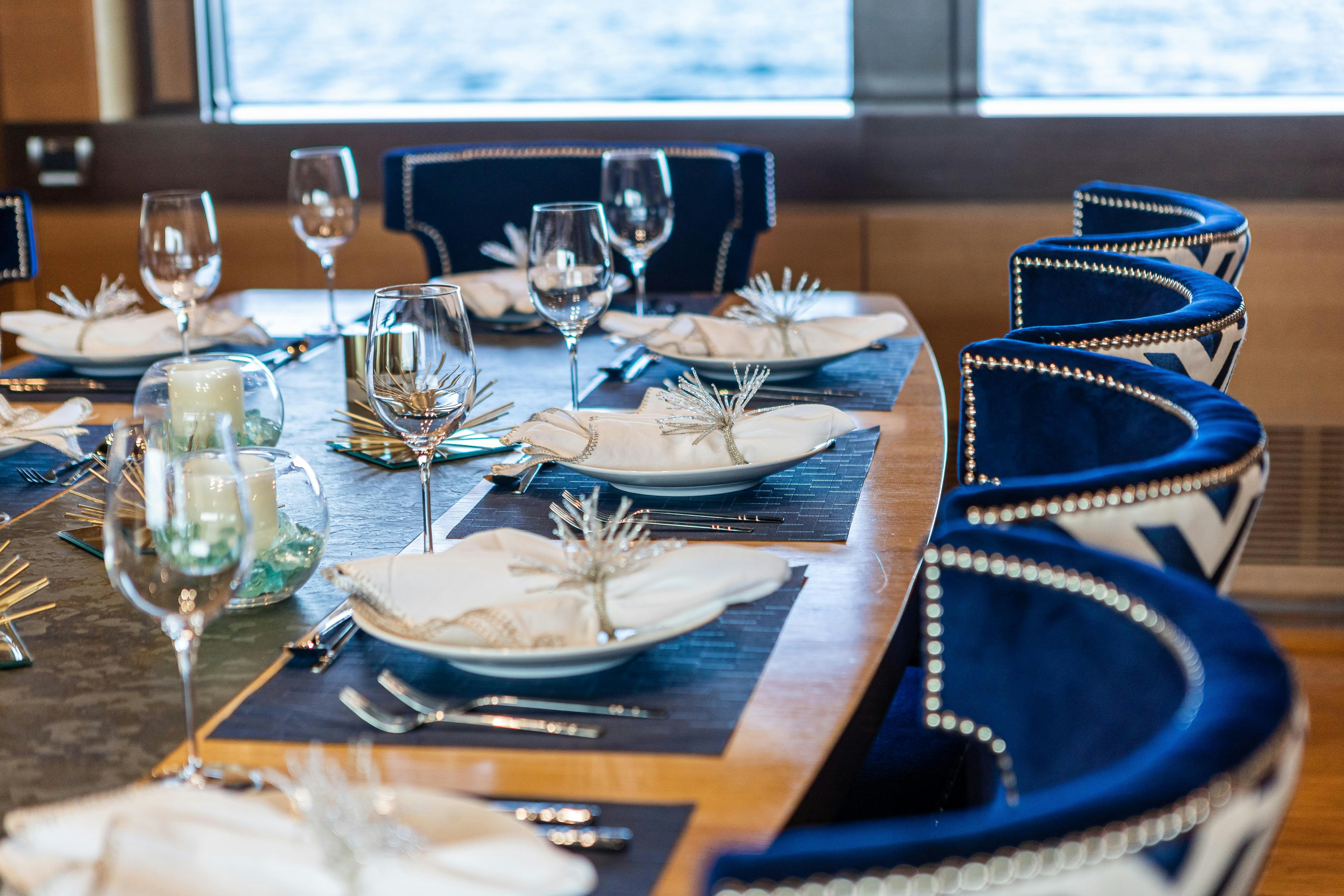 a table with plates and glasses aboard SWEET CAROLINE Yacht for Charter