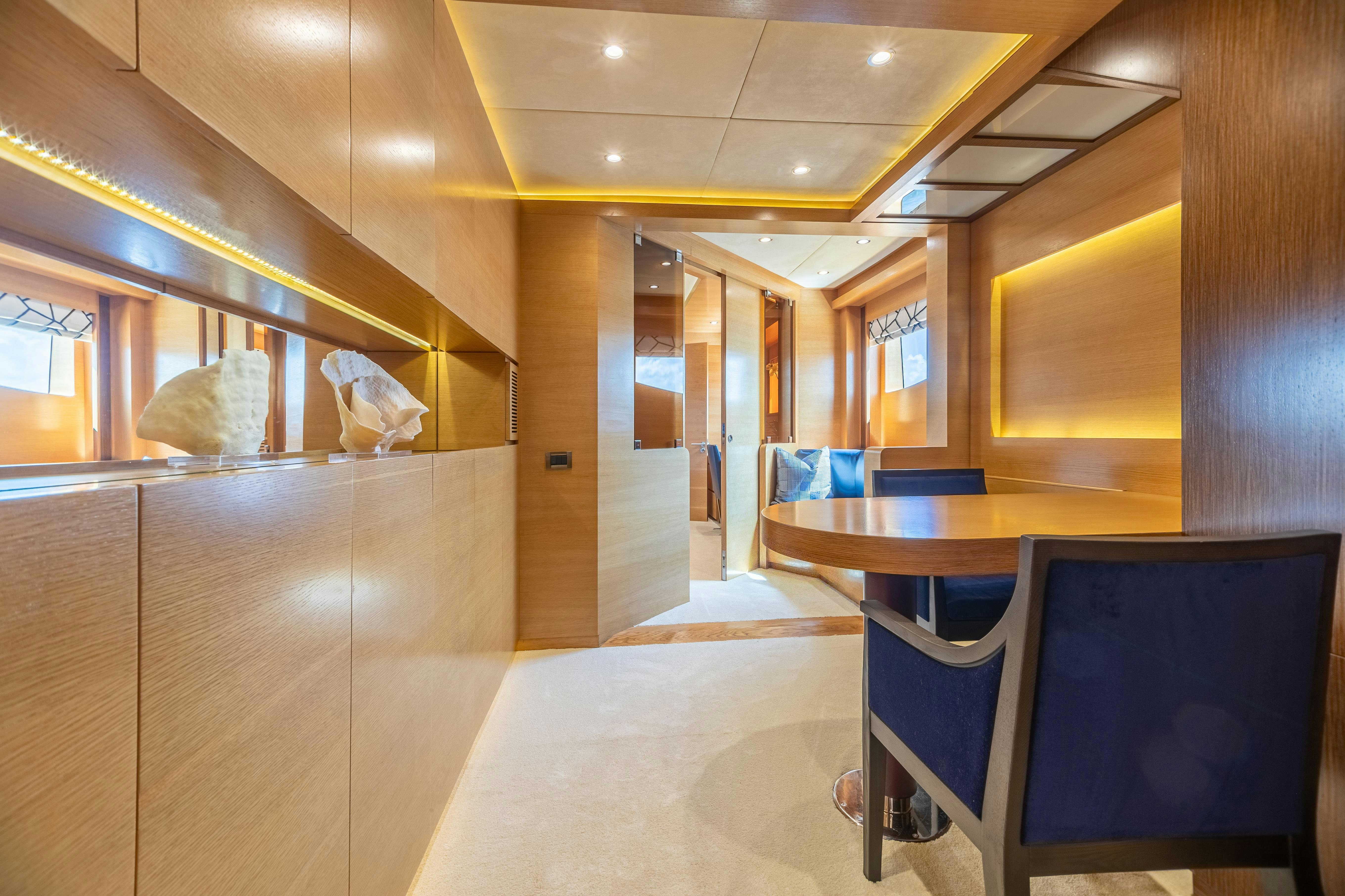 a room with a desk and chairs aboard SWEET CAROLINE Yacht for Charter