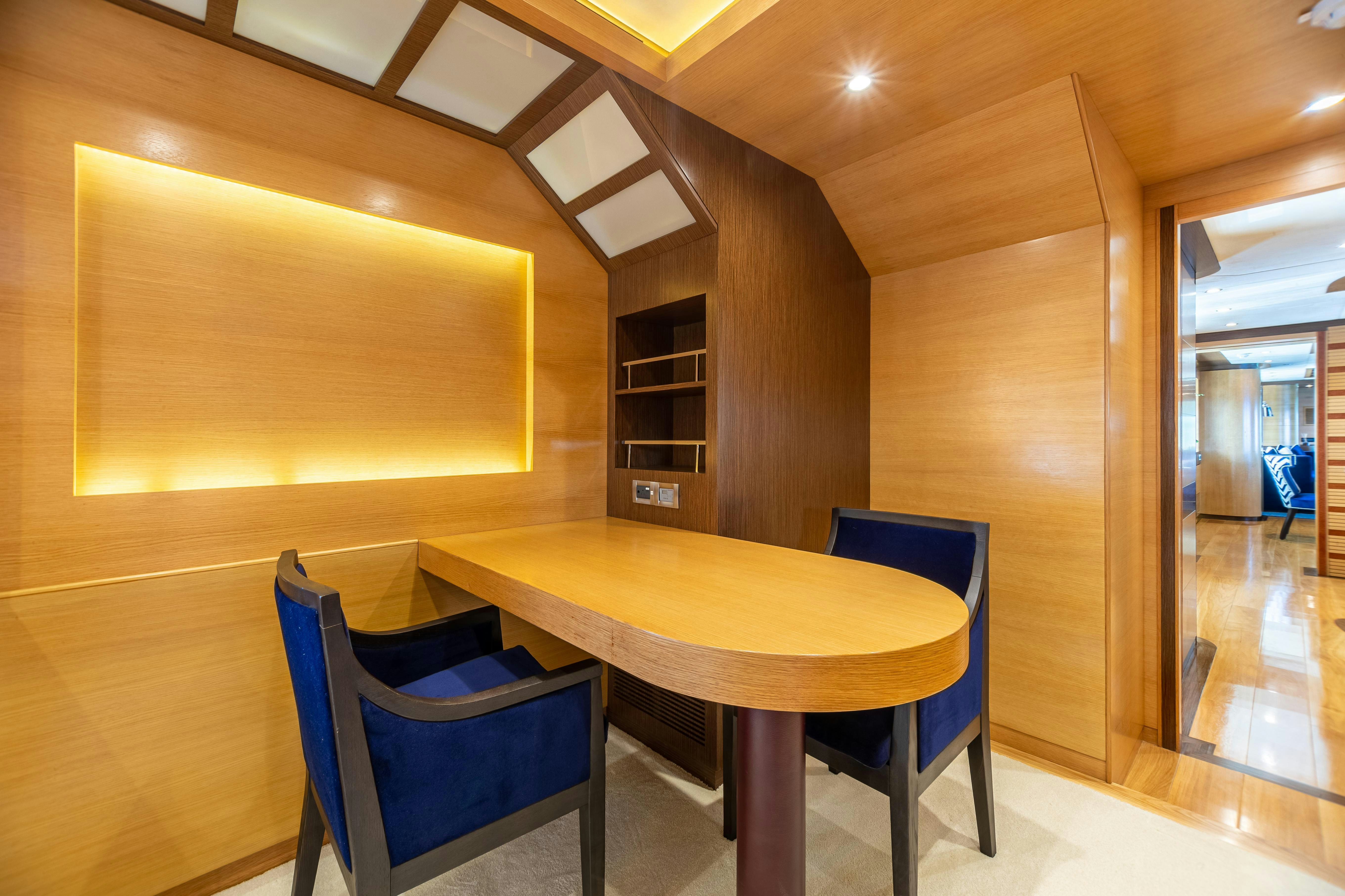 a room with a table and chairs aboard SWEET CAROLINE Yacht for Charter