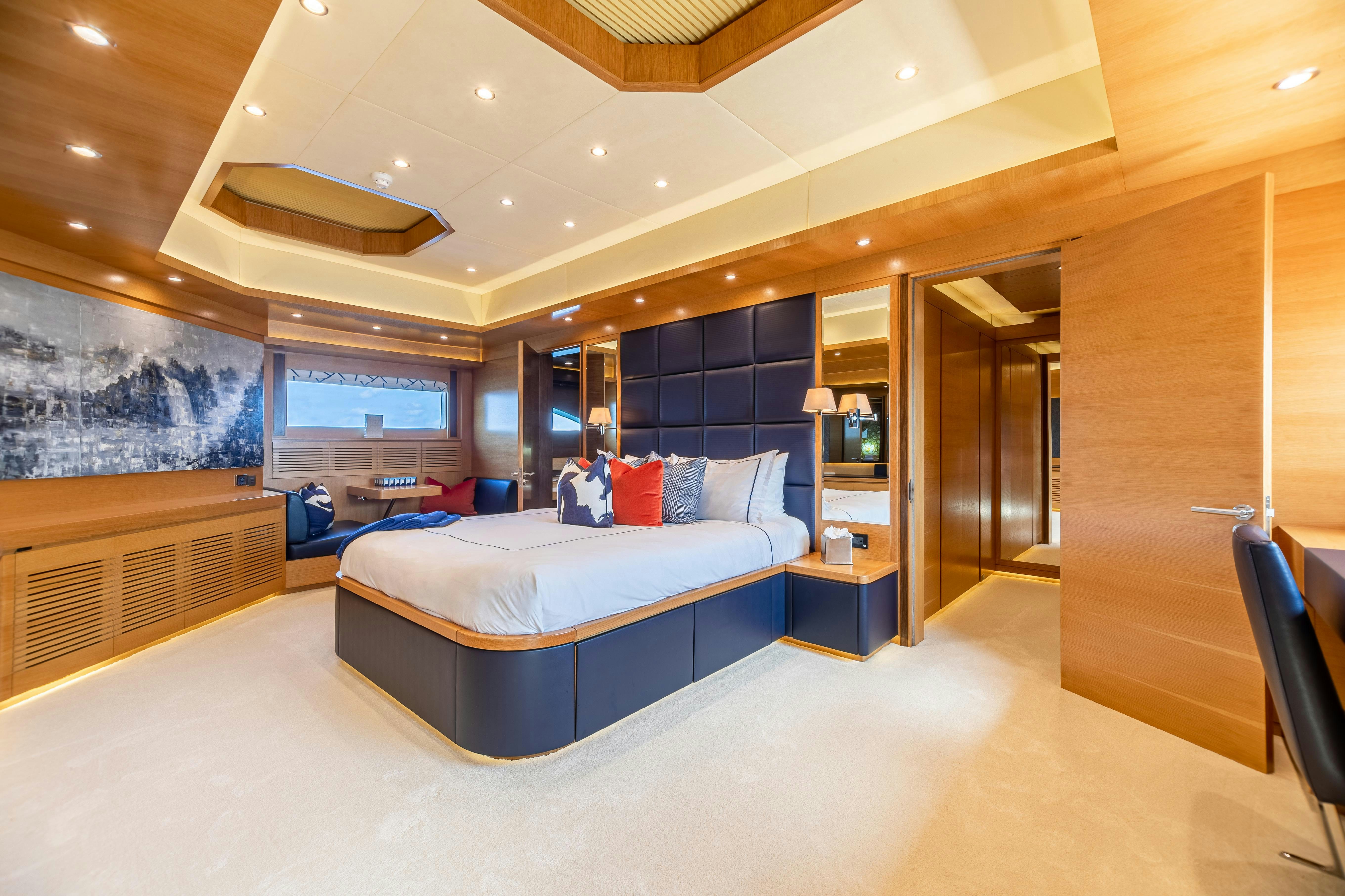 a room with a bed and a desk aboard SWEET CAROLINE Yacht for Charter