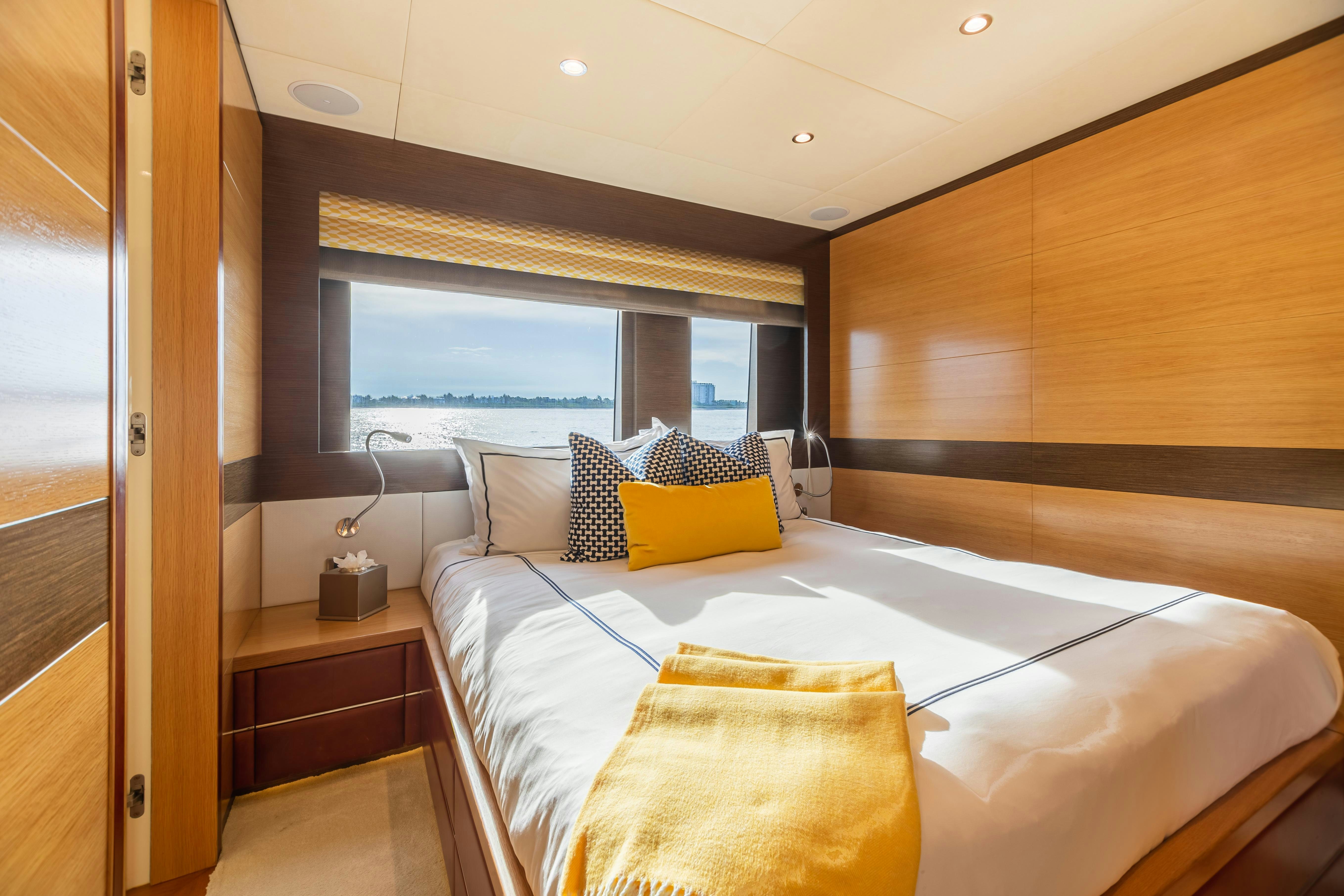 a room with a bed and a window aboard SWEET CAROLINE Yacht for Charter