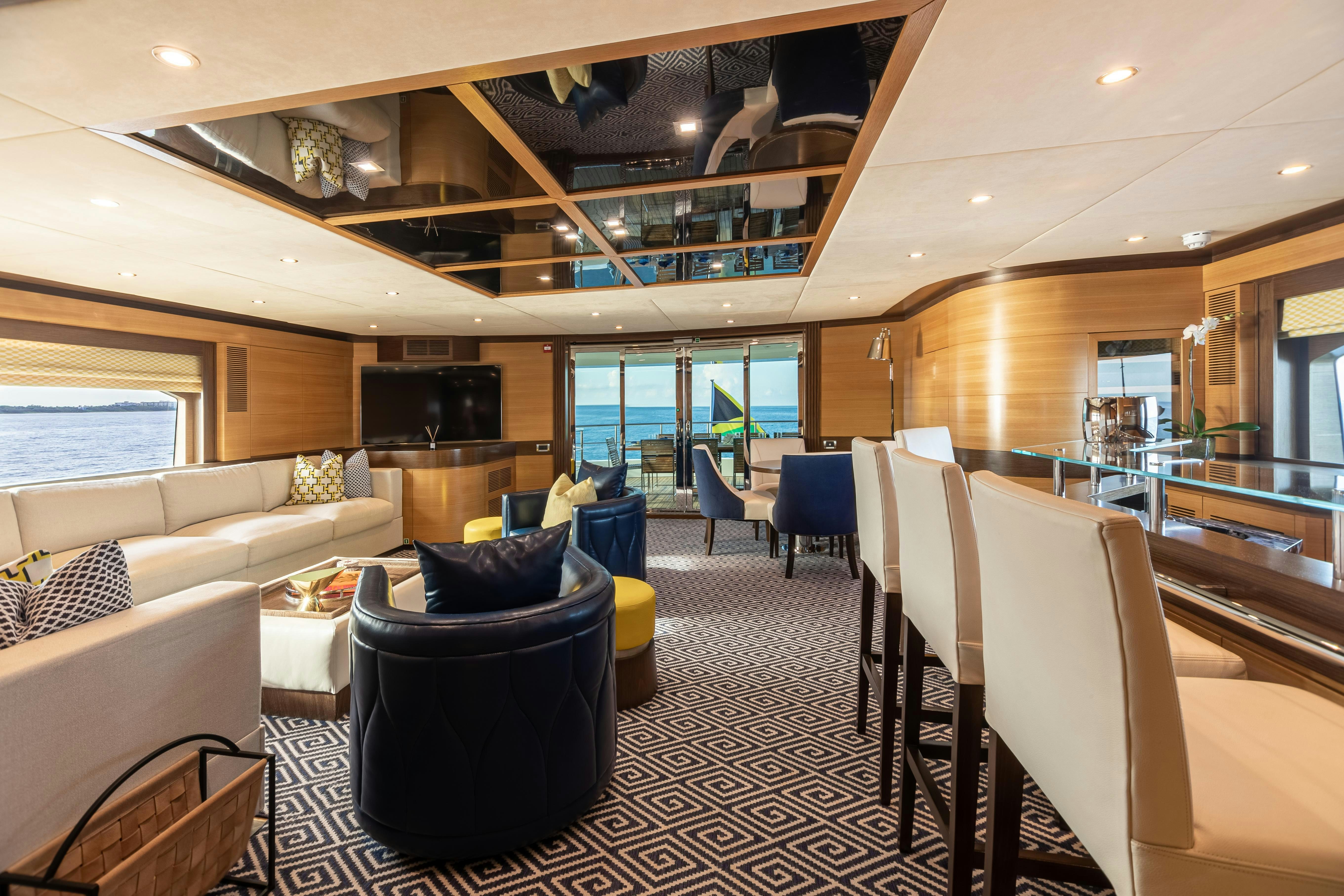 a room with a couch and chairs aboard SWEET CAROLINE Yacht for Charter