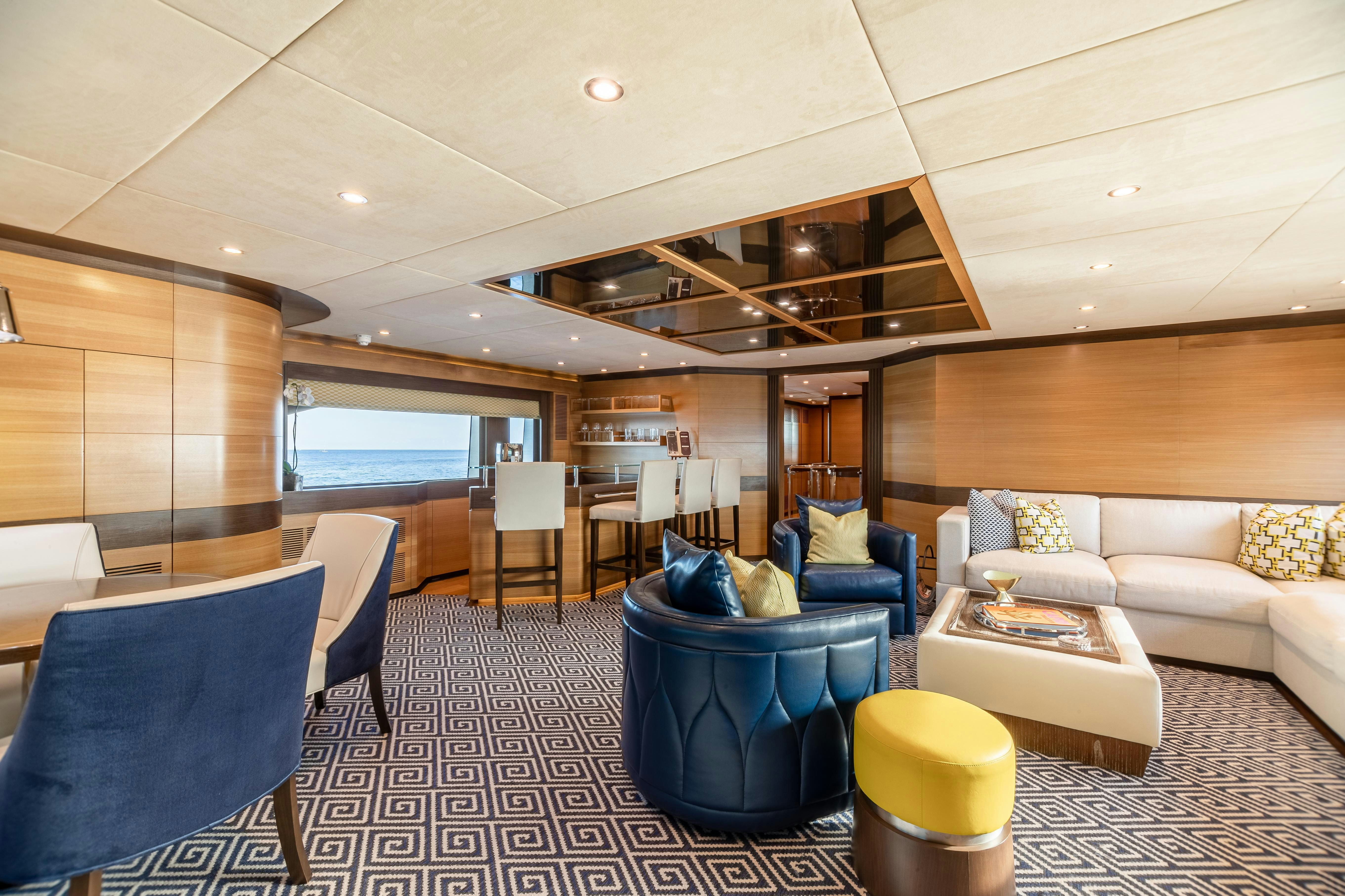 a living room with a couch and a table aboard SWEET CAROLINE Yacht for Charter