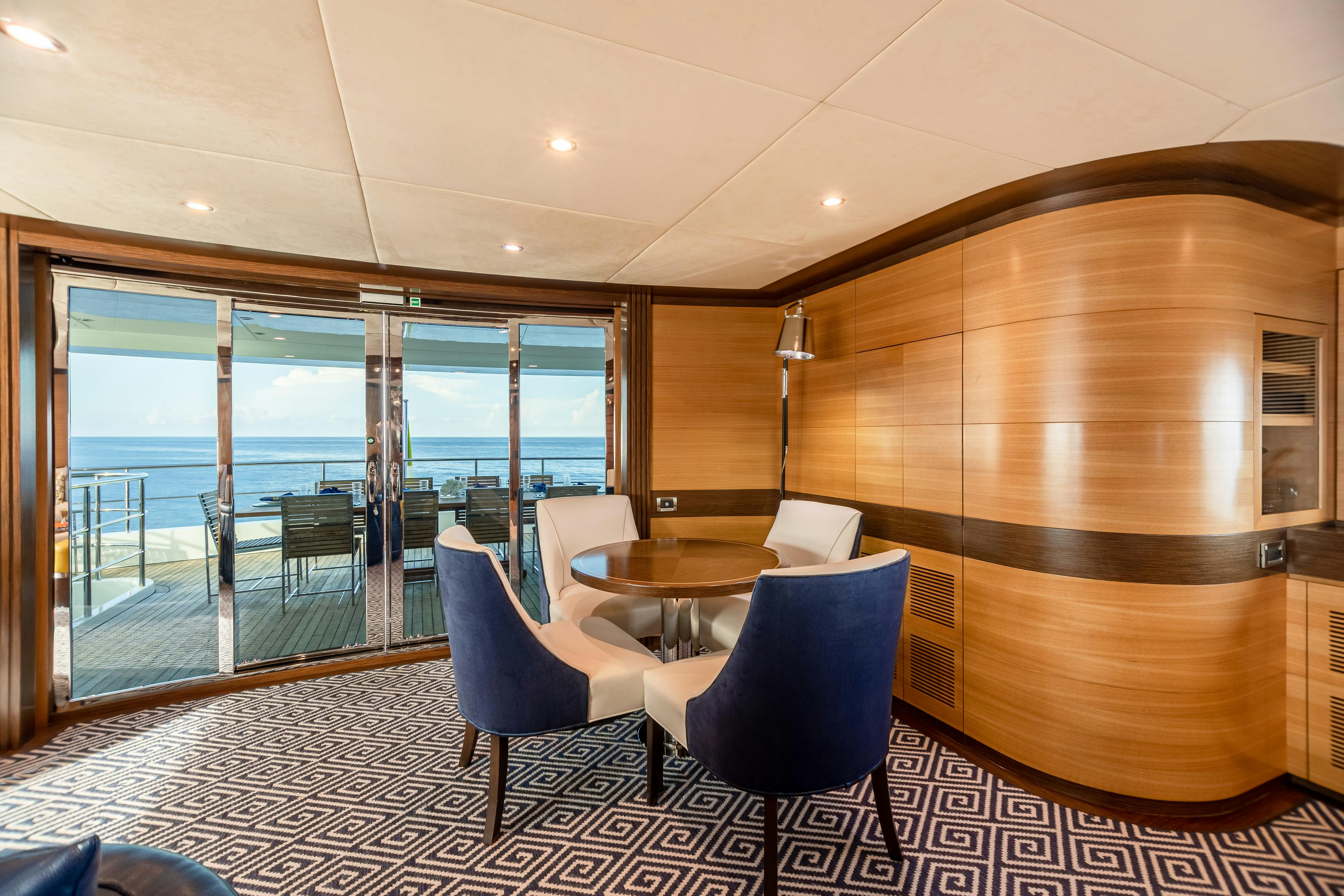 a room with a table and chairs aboard SWEET CAROLINE Yacht for Charter