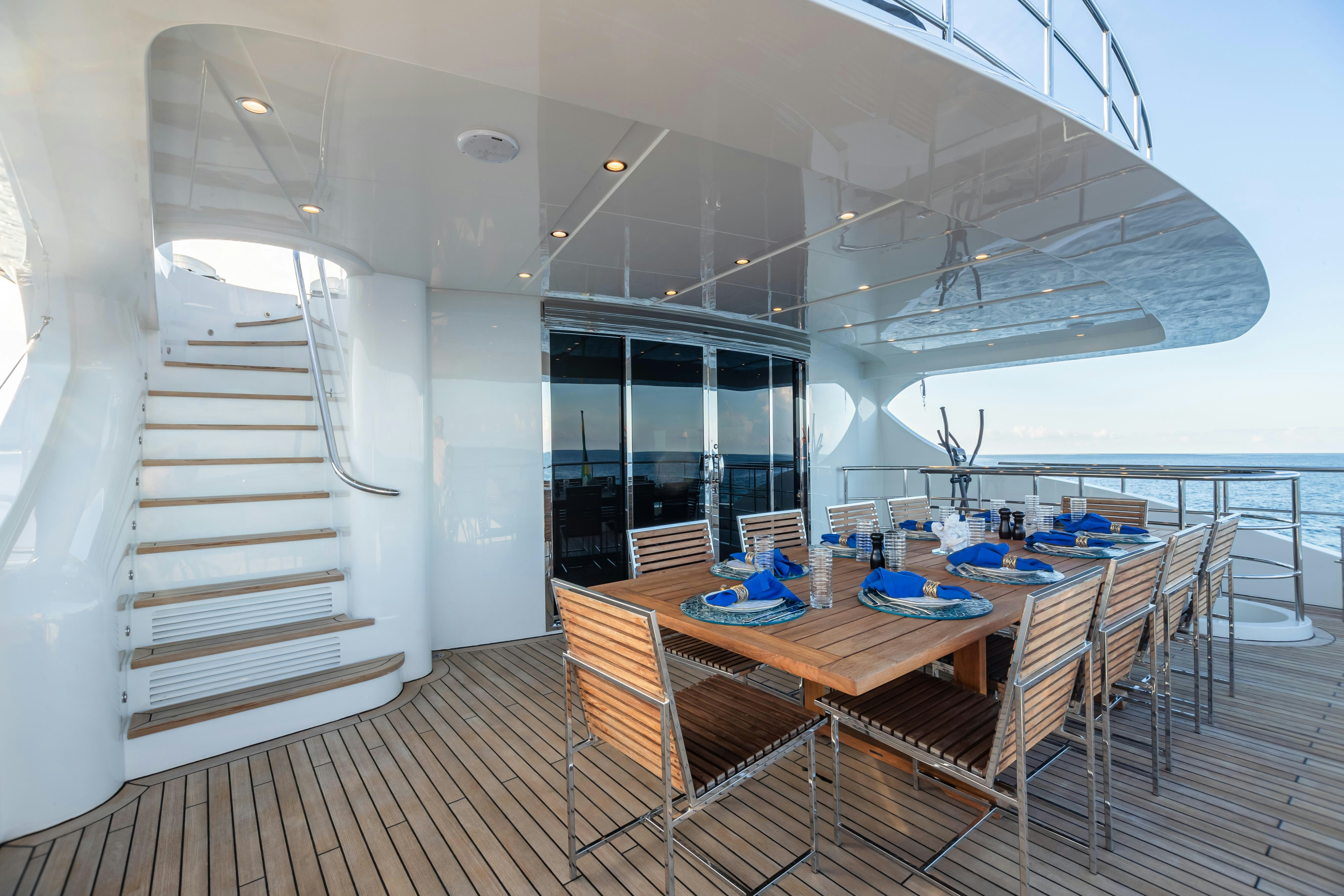 a long table and chairs on a deck aboard SWEET CAROLINE Yacht for Charter