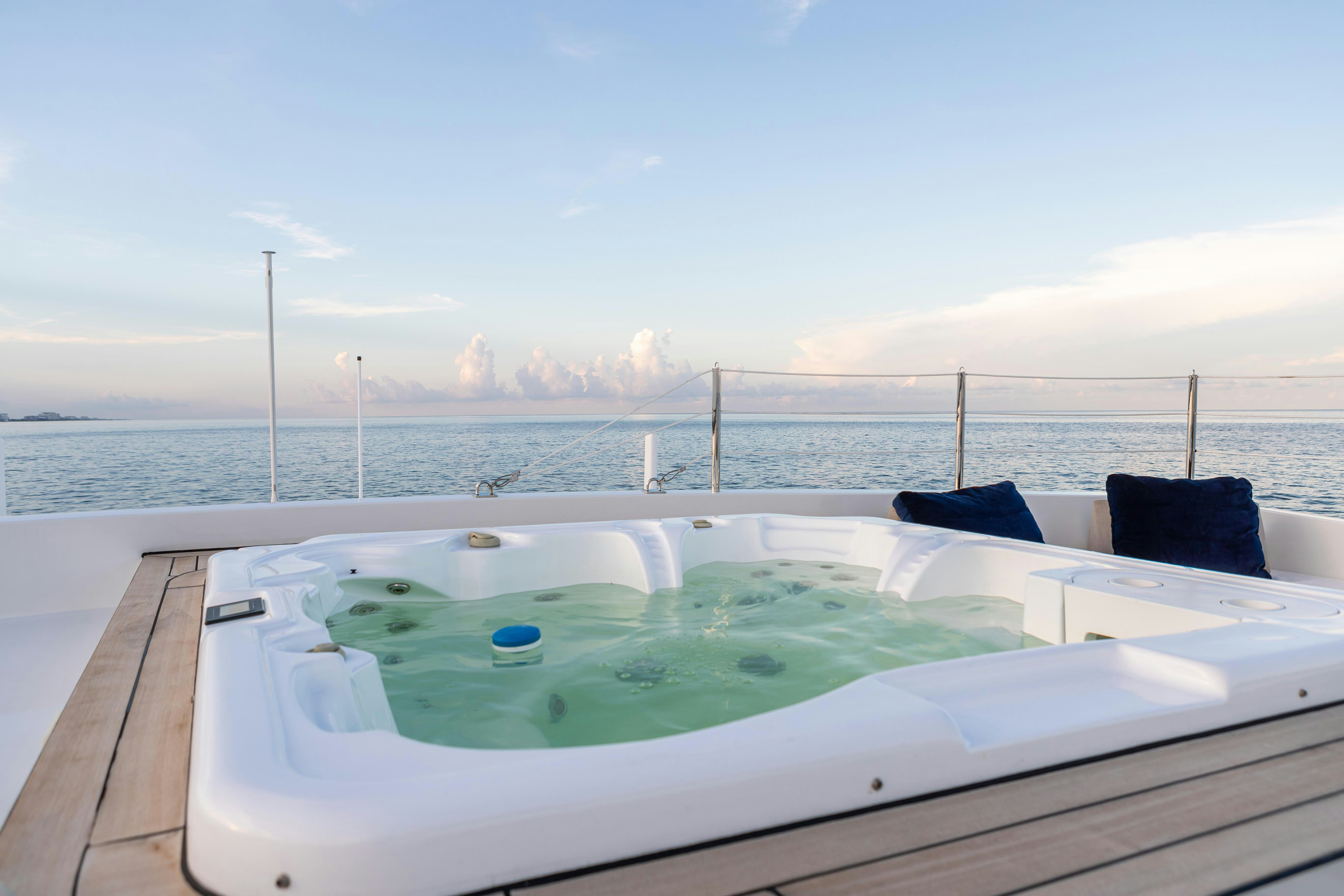 a pool on a deck overlooking a city aboard SWEET CAROLINE Yacht for Charter