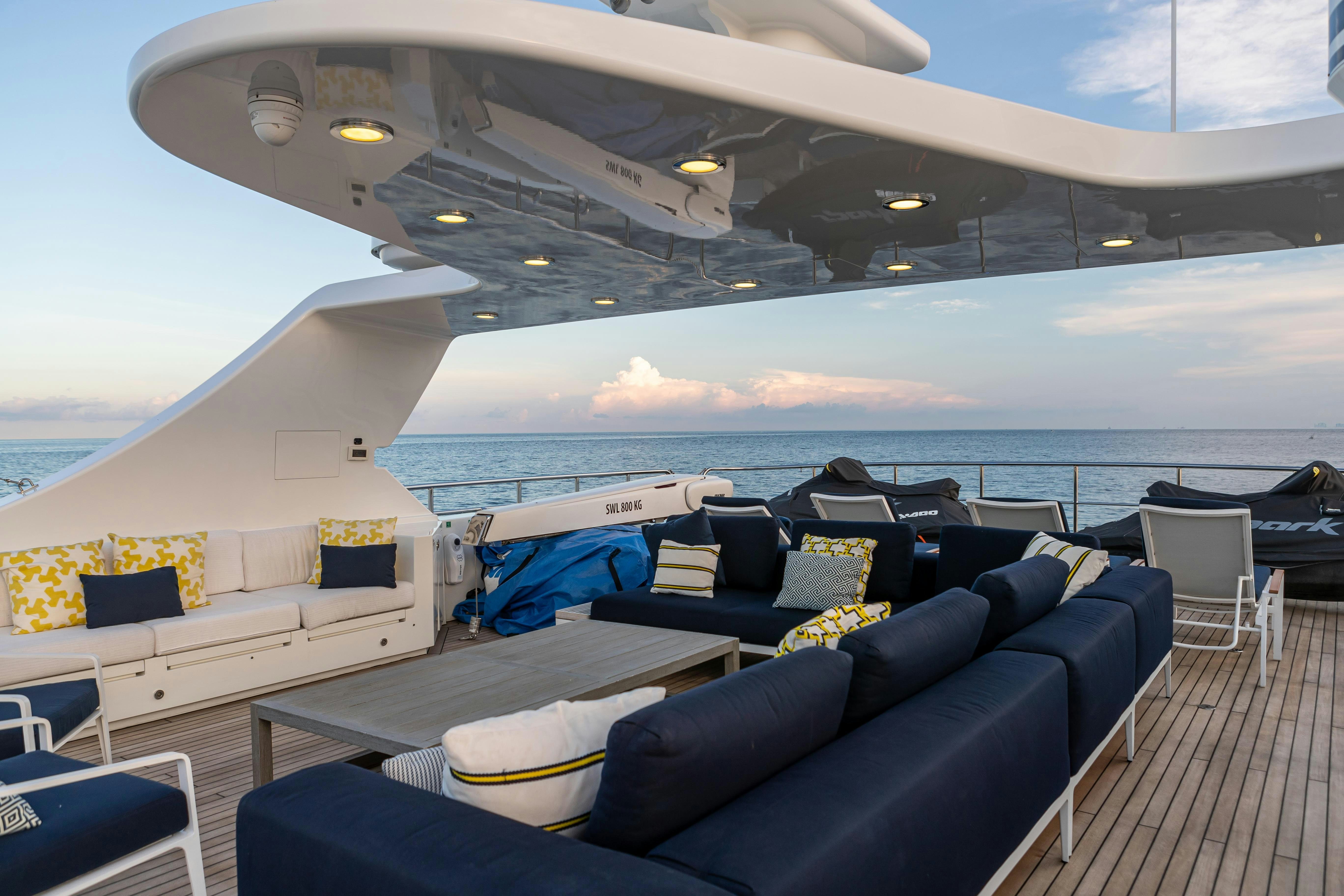 a large cruise ship with a lounge chair and a large body of water aboard SWEET CAROLINE Yacht for Charter