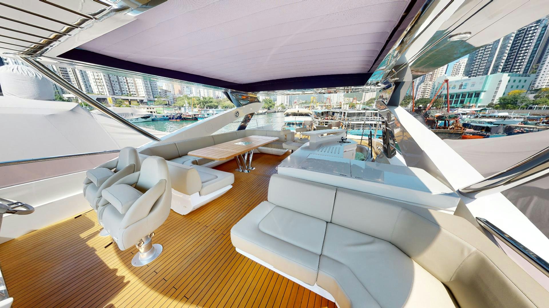 a room with a large deck and a view of a city aboard A & K Yacht for Sale