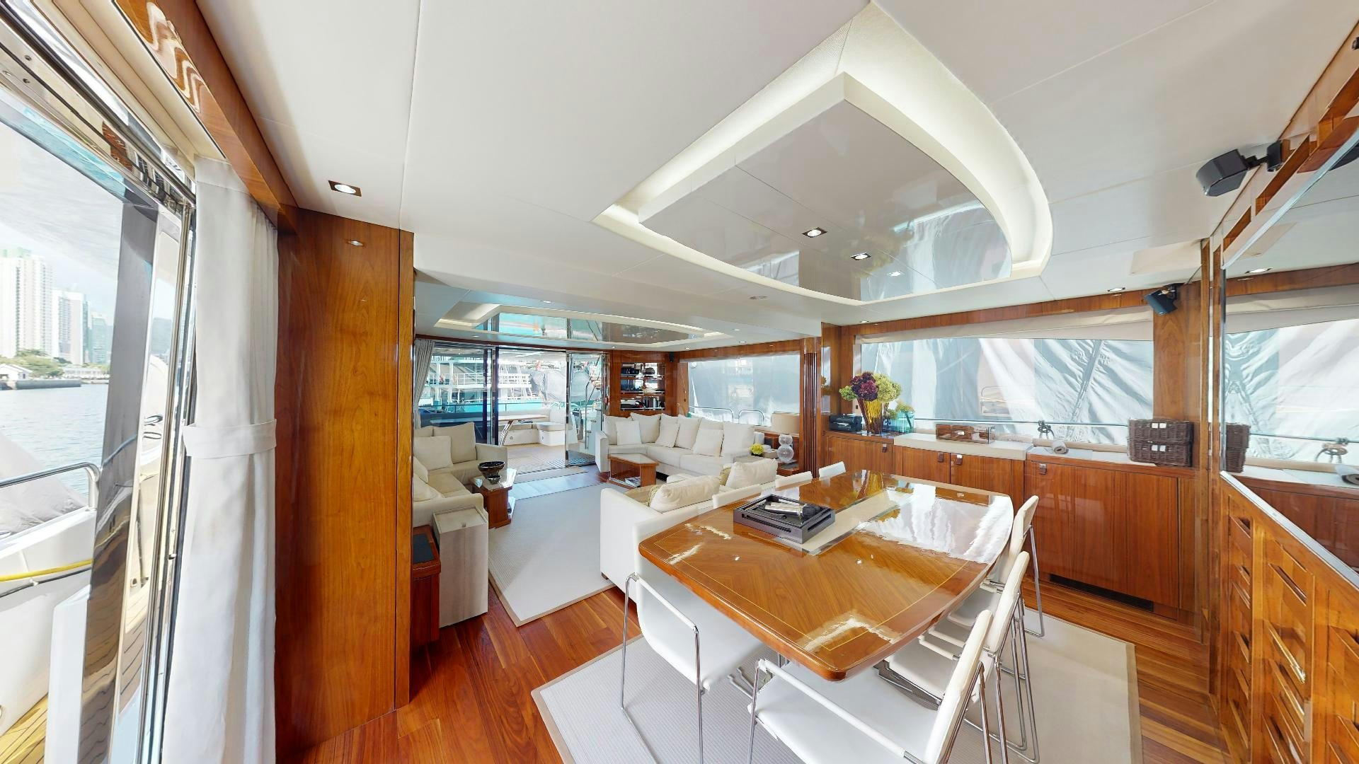 a large room with a table and chairs aboard A & K Yacht for Sale