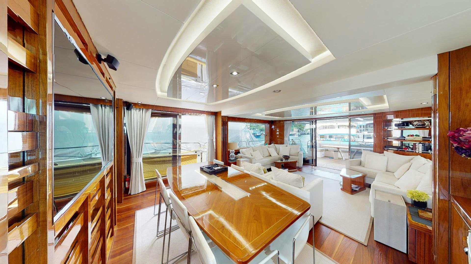 a large living room with a large open window aboard A & K Yacht for Sale