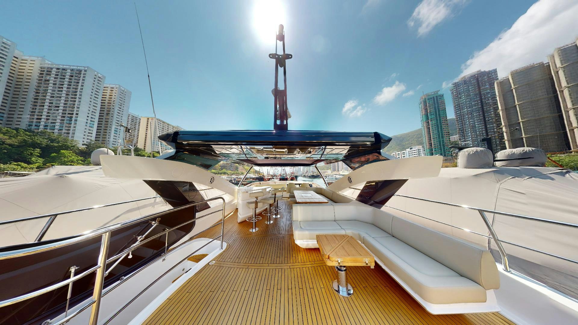 a deck with a large ship in the water and a city in the background aboard A & K Yacht for Sale
