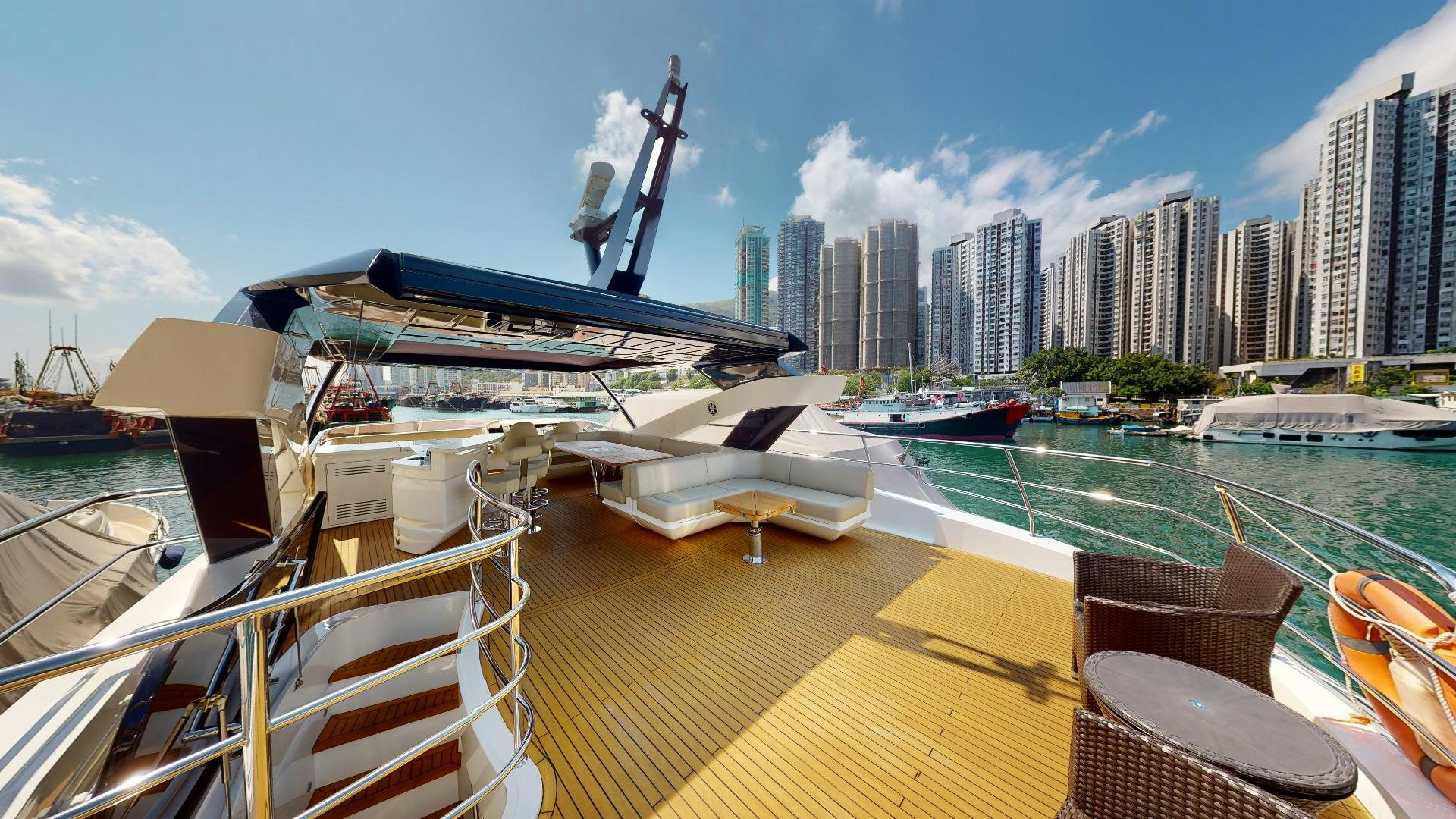 a deck with a view of a city and a large body of water aboard A & K Yacht for Sale