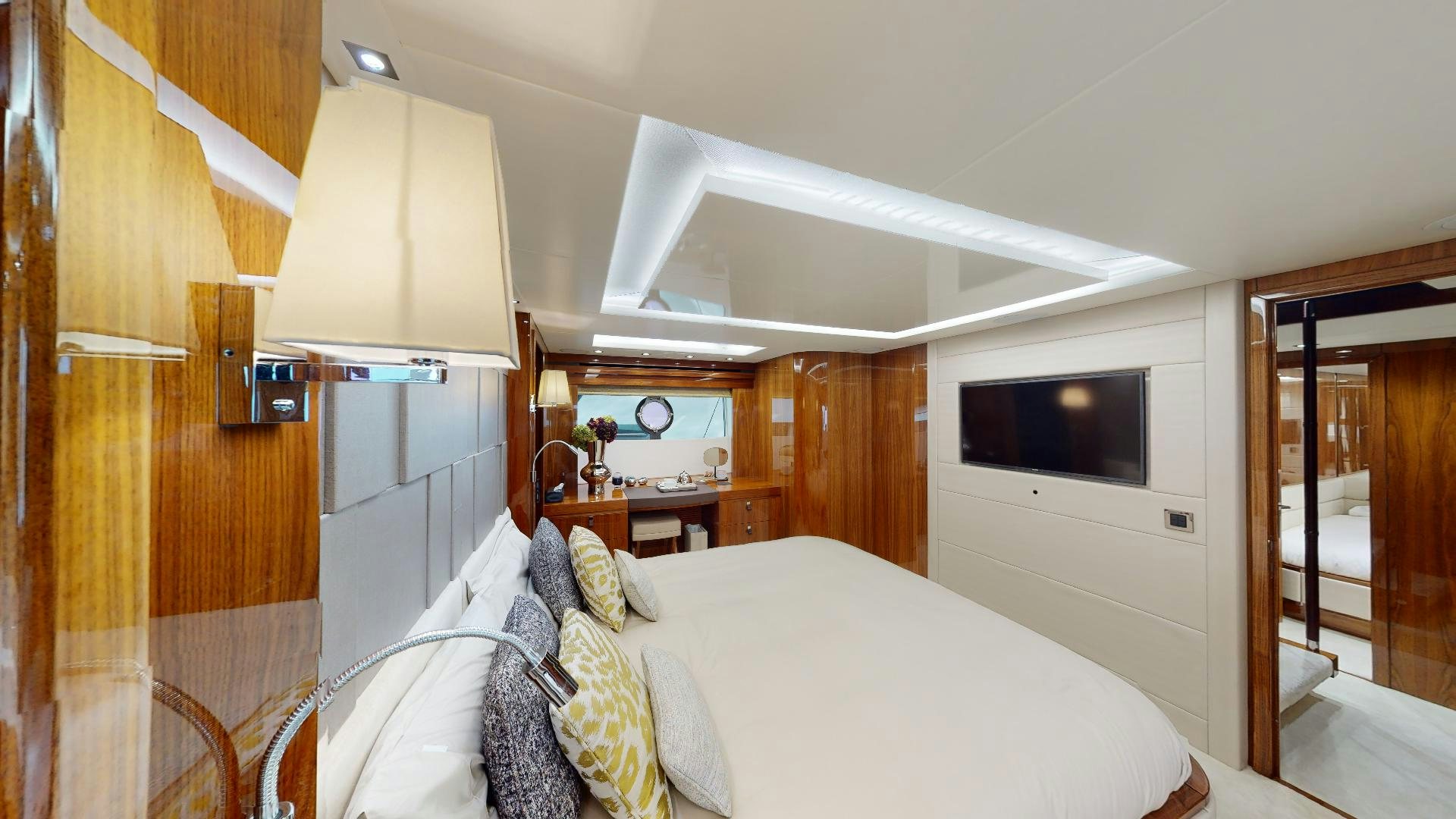 a bedroom with a bed and a television aboard A & K Yacht for Sale