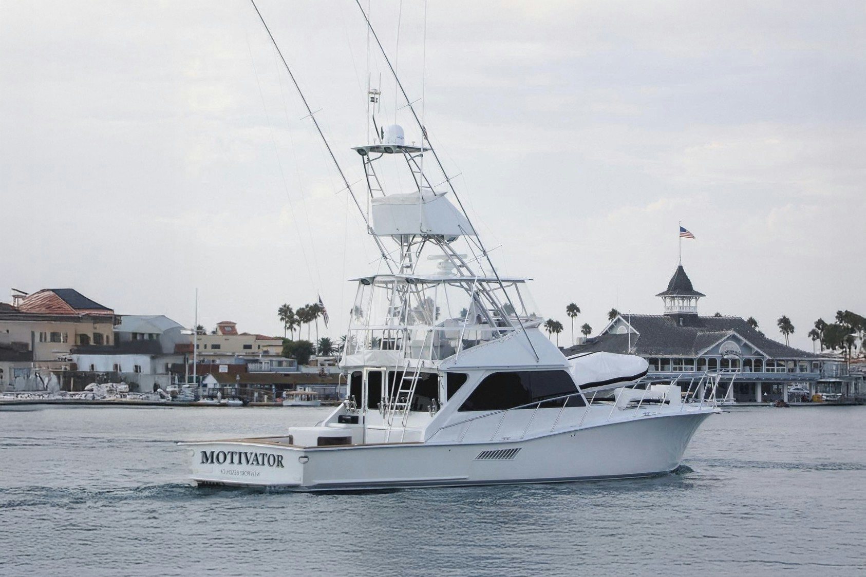 a white boat in the water aboard MOTIVATOR Yacht for Sale