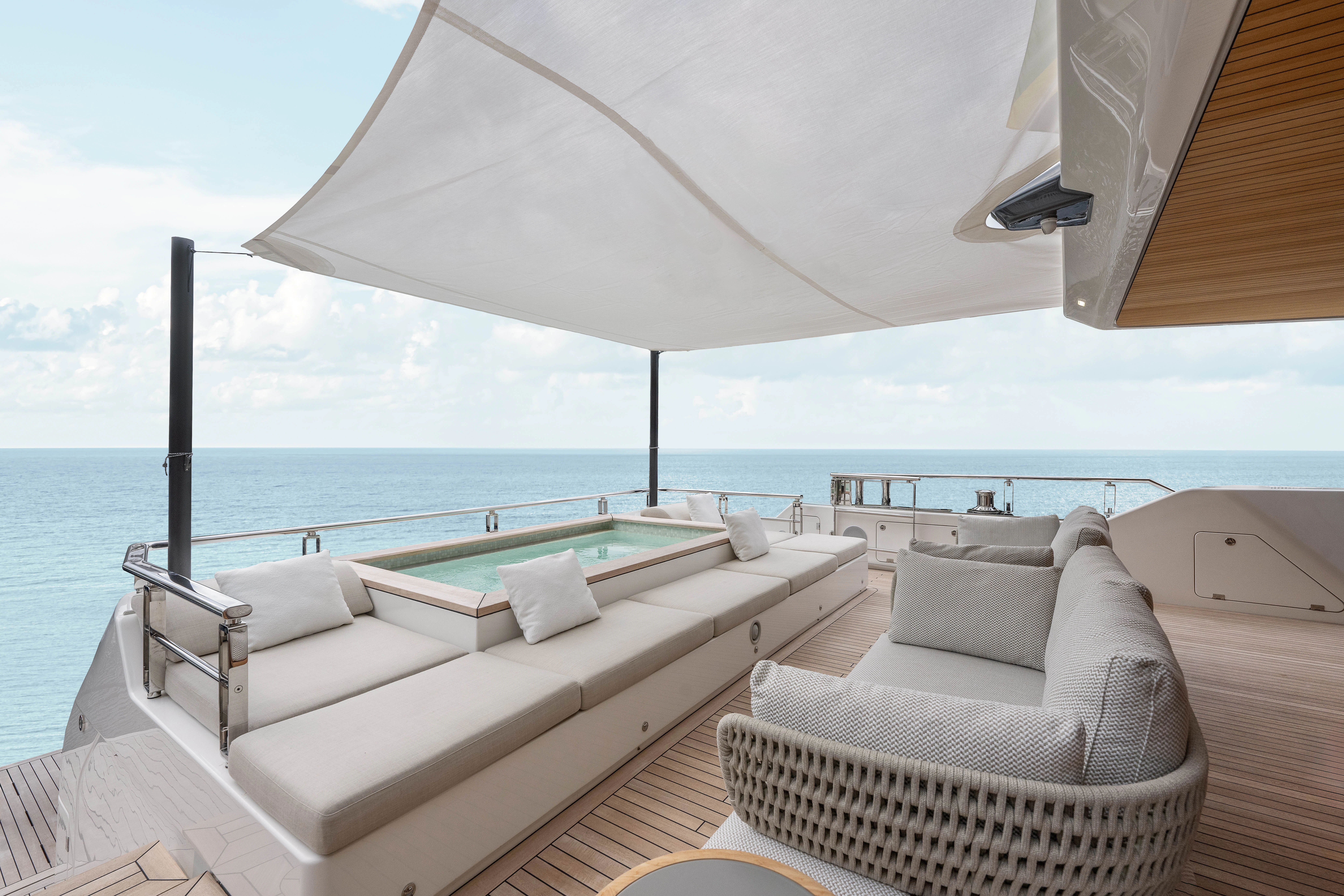 a lounge chair and a bed on a boat aboard ANDREIKA V Yacht for Charter